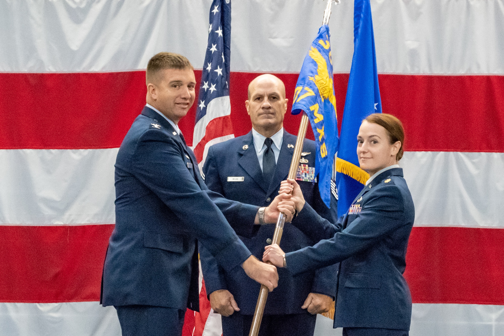 U.S. Air Force Col. Casey Cooley, 307th Maintenance Group commander, hands the 707th Maintenance Squadron guidon to the unit’s new commander Maj. Jessica Oberlander, during the unit’s change of command ceremony at Barksdale Air Force Base, Louisiana, August 5, 2018.   Oberlander comes to the unit from Headquarters, U.S. Air Force in Washington D.C. where she served as the chief for Global Power Product Support Integration and Oversight. (U.S. Air Force photo by Technical Sgt. Cody Burt/Released)
