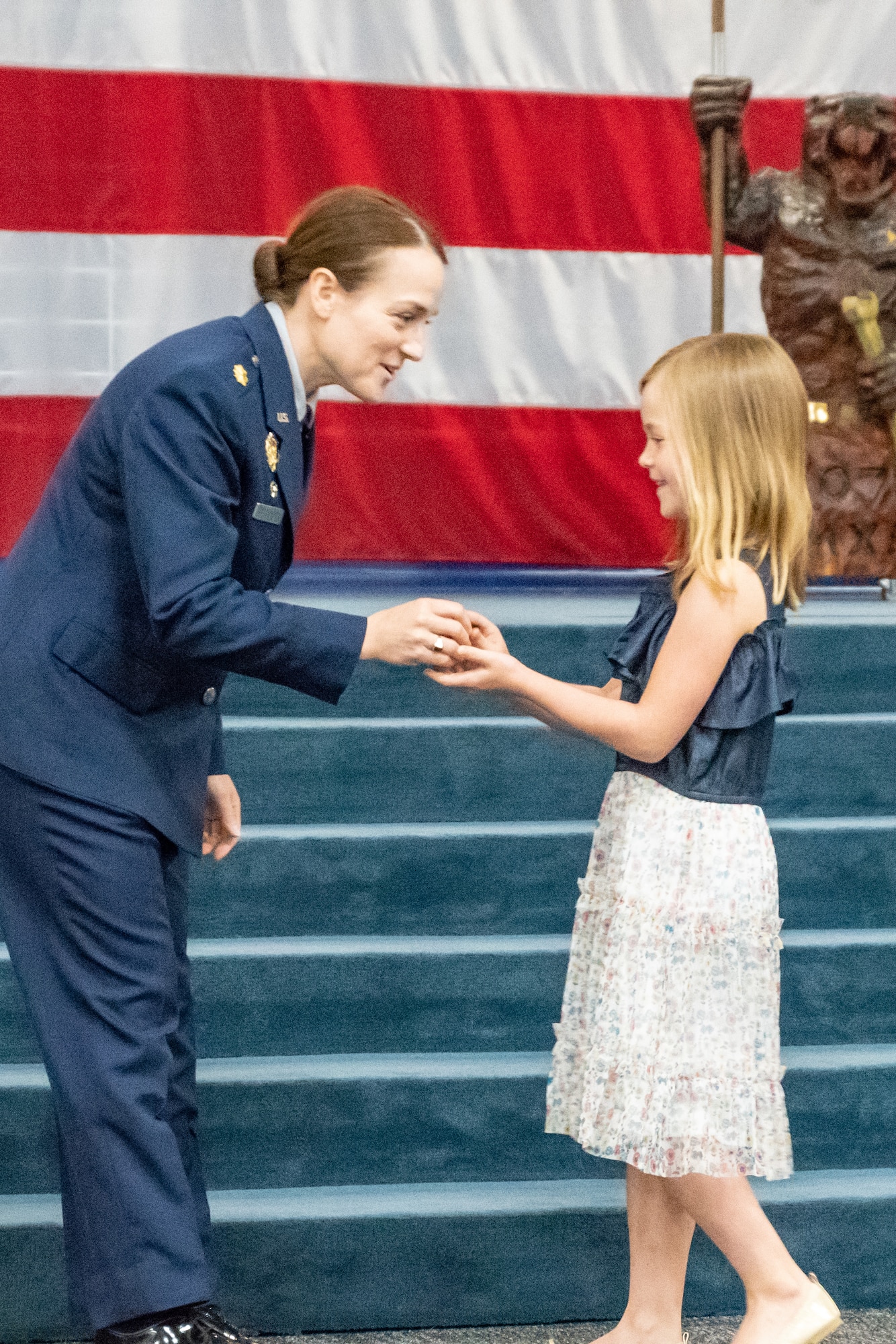 U.S. Air Force Maj. Jessica Oberlander, 707th Maintenance Squadron commander, speaks with her daughter, Lillian, at Barksdale Air Force Base, Louisiana, August 5, 2018.  Oberlander took command of the unit during a ceremony attended by 307th Bomb Wing leadership and other Airmen from around the unit.  (U.S. Air Force photo by Technical Sgt. Cody Burt/Released)