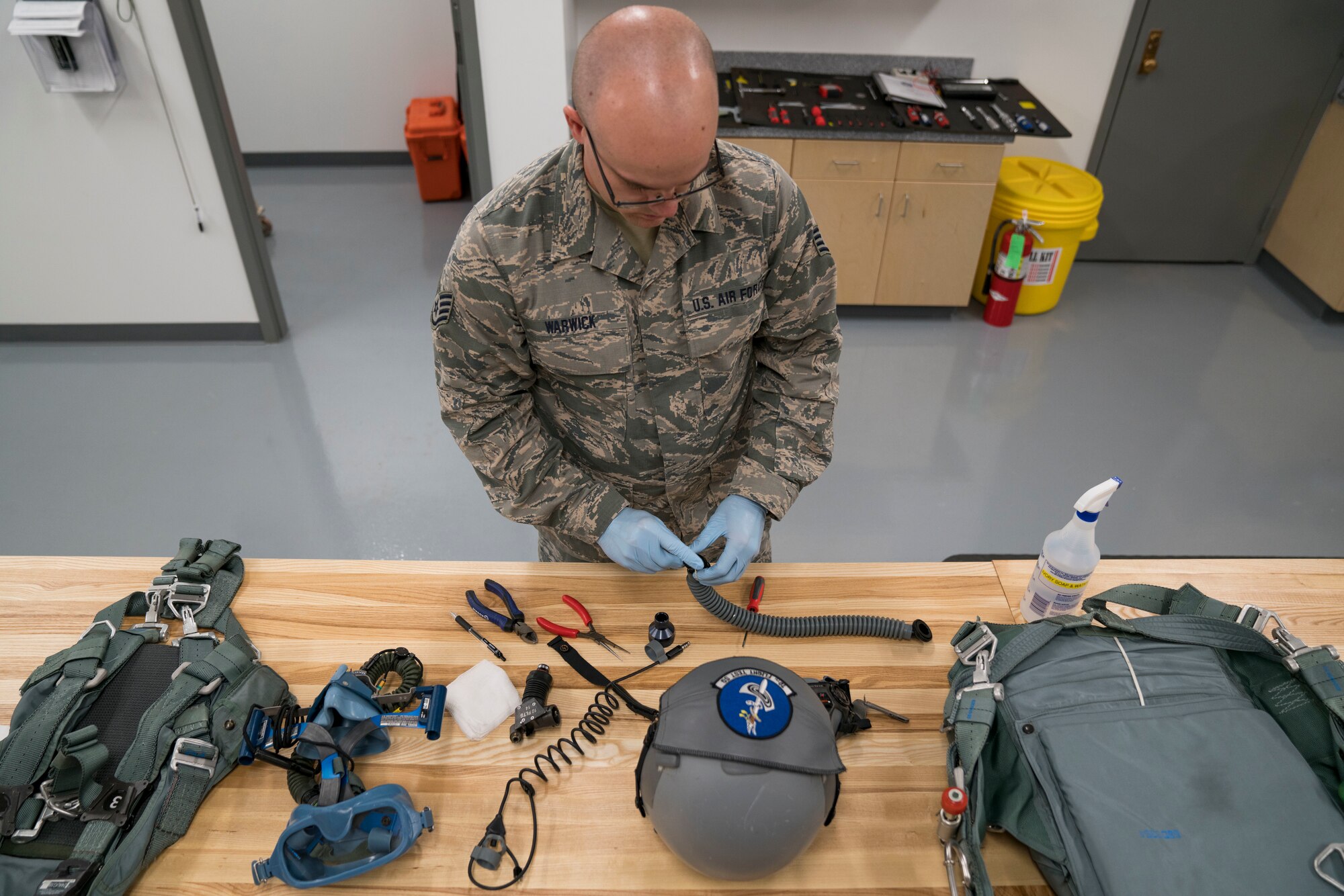 Staff Sgt. Miles Warwick inspects aircrew flight equipment.