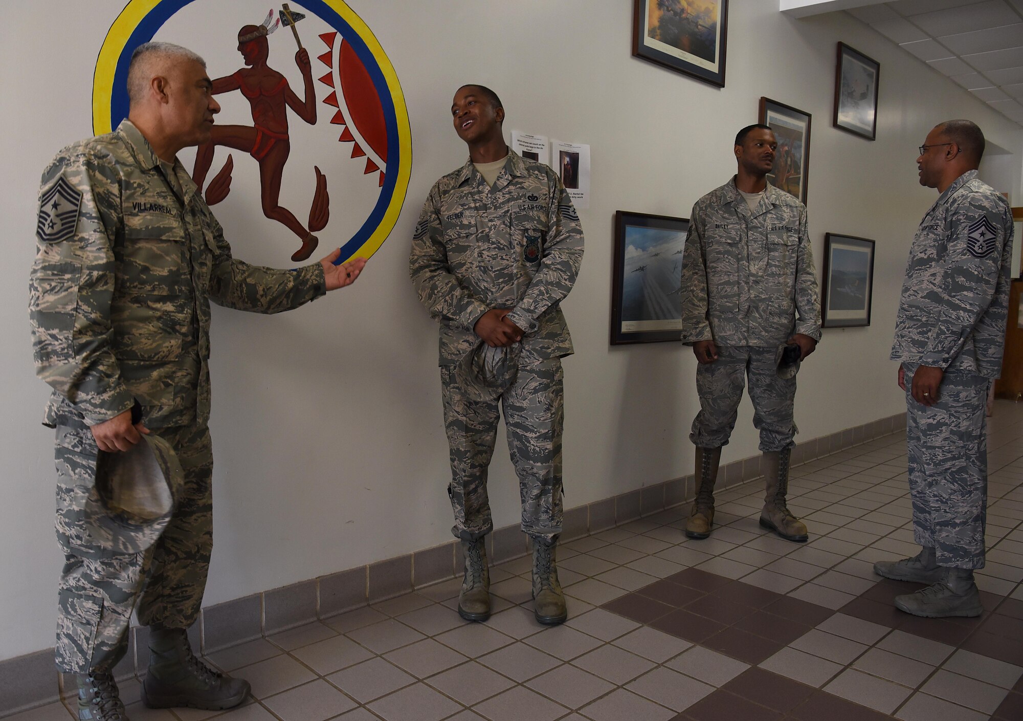 Chief Master Sgt. Raul Villarreal, Jr., 14th Flying Training Wing command chief, speaks to Tech Sgt. Crayton Felder, 14th Civil Engineer Squadron firefighter, after Chief Master Sgt. David Brown, 19th Air Force command chief, held an NCO all call Aug. 6, 2018, on Columbus Air Force Base, Mississippi. He advised staff and technical sergeants on making sure they are making an impact on the war on terror every time they show up to work, because everyone is a piece of a large and important puzzle, keeping Americans safe at any moment of any day. (U.S. Air Force photo by Airman 1st Class Keith Holcomb)