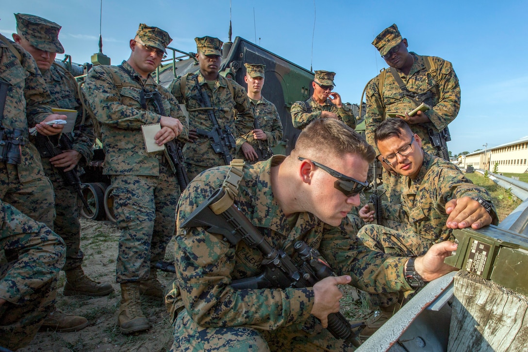 Marines gather around a radio.