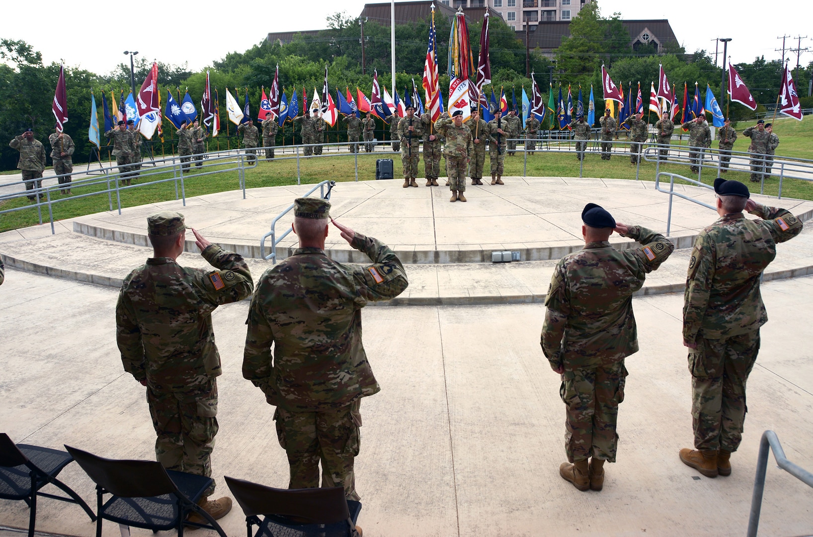 Members of the Regional Health Command-Central command team salute the American flag during the National Anthem during an assumption of responsibility ceremony at the U.S. Army Medical Museum Amphitheatre at Joint Base San Antonio-Fort Sam Houston Aug. 6. From left are Lt. Col. Kenny Wells, Col. John Lamoureux, Command Sgt. Maj. Joseph Cecil and Brig. Gen. Jeffrey Johnson.
