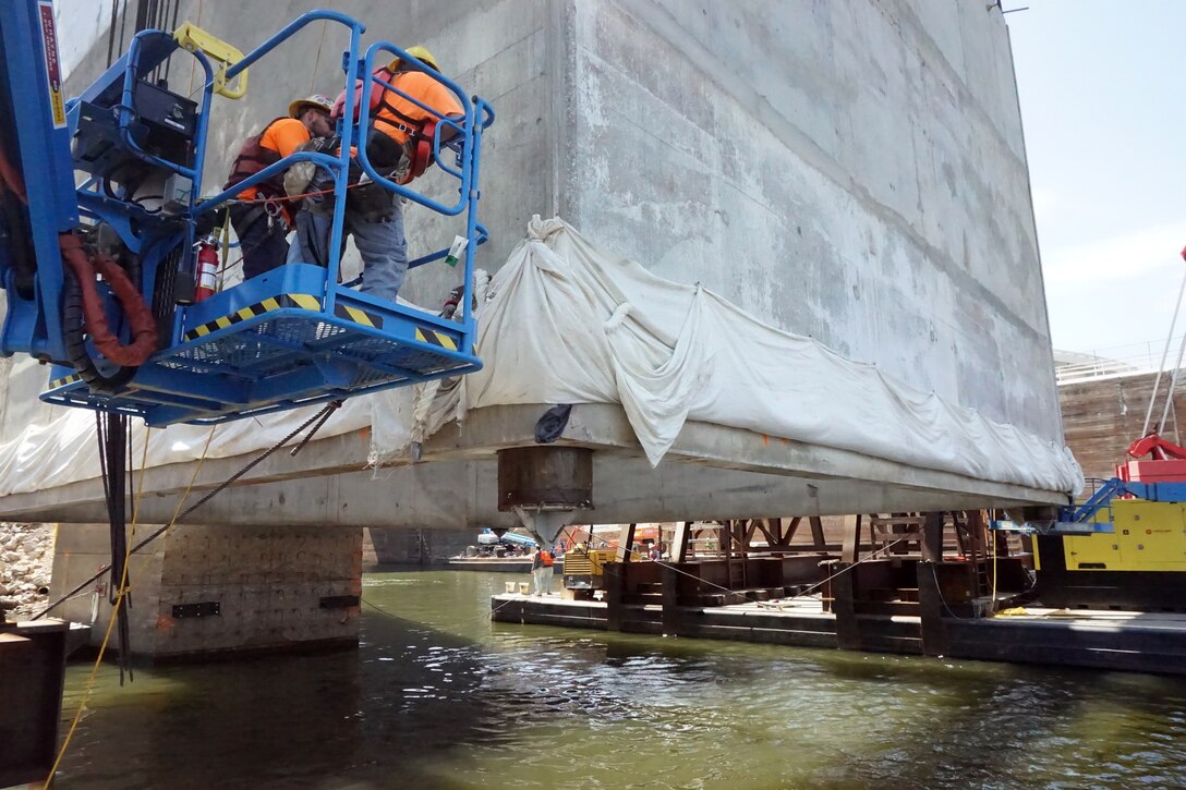 The U.S. Army Corps of Engineers Nashville District and its contractor partner Johnson Brothers put a 1.3 million pound concrete shell into position Aug. 6, 2018 on the riverbed on downstream end of Kentucky Lock where it will be part of a coffer dam and eventually a permanent part of the new lock wall for the Kentucky Lock Addition Project. It is the first of 10 shells that will be placed over the next year. The lock is located at Kentucky Dam, which is a Tennessee Valley Authority project at Tennessee River mile 22.4. (USACE Photo by Mark Rankin)