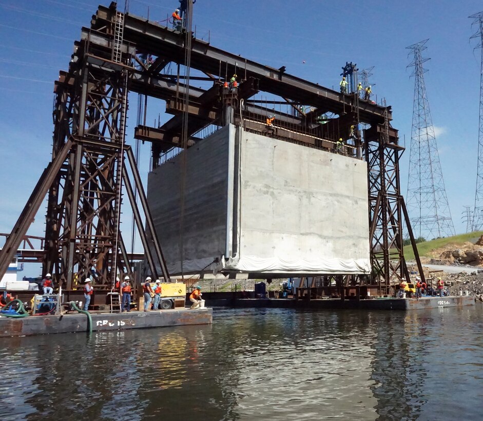 The U.S. Army Corps of Engineers Nashville District and its contractor partner Johnson Brothers put a 1.3 million pound concrete shell into position Aug. 6, 2018 on the riverbed on downstream end of Kentucky Lock where it will be part of a coffer dam and eventually a permanent part of the new lock wall for the Kentucky Lock Addition Project. It is the first of 10 shells that will be placed over the next year. The lock is located at Kentucky Dam, which is a Tennessee Valley Authority project at Tennessee River mile 22.4. (USACE Photo by Mark Rankin)