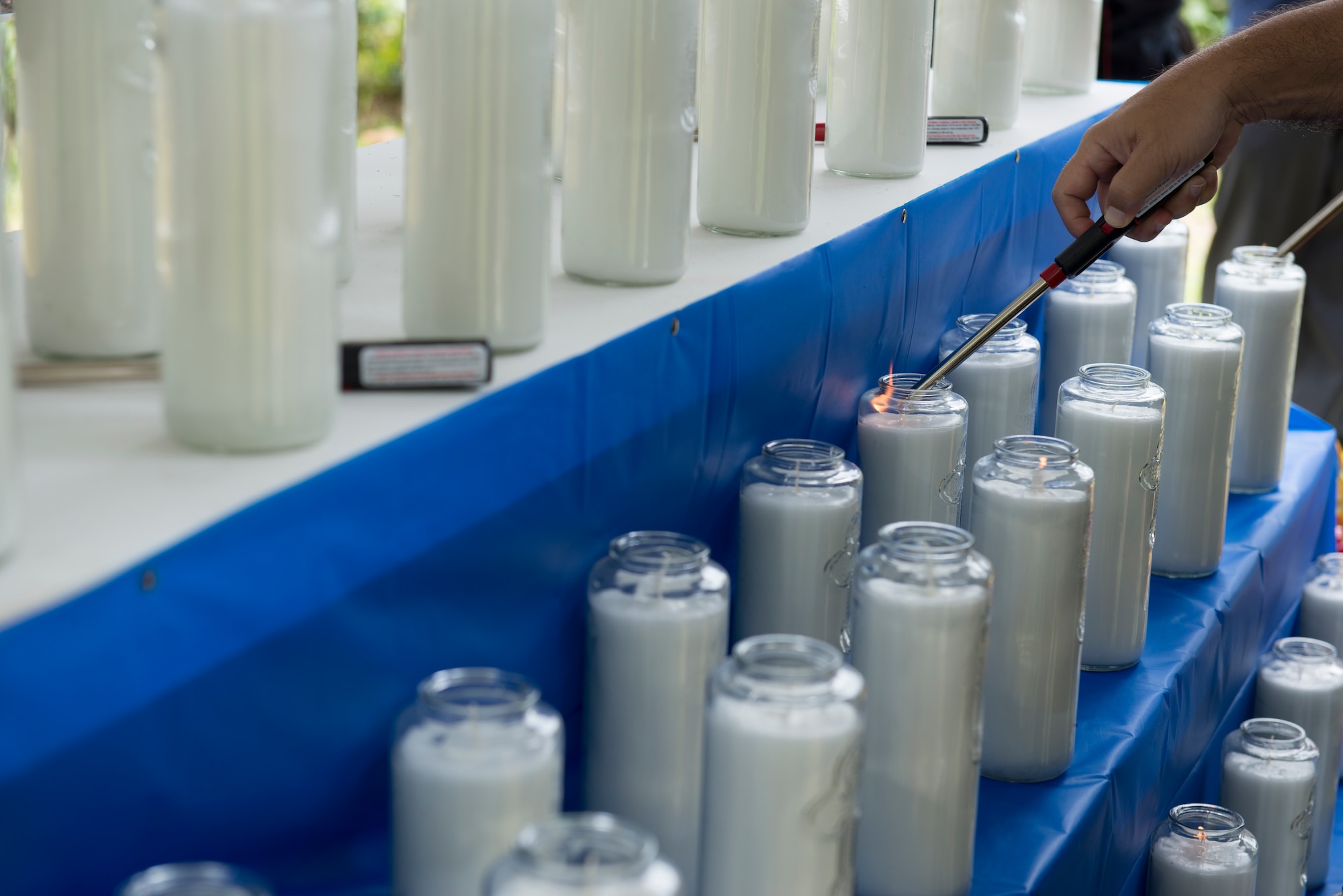 Candles are lit in honor of victims of the Chaguian massacre as part of the Chaguian Massacre Memorial August 8, 2018, in Yigo, Guam. The candles are lit by service members, Japanese dignitaries, and relatives of the deceased. (U.S. Air Force photo by Tech. Sgt. Jake M. Barreiro)