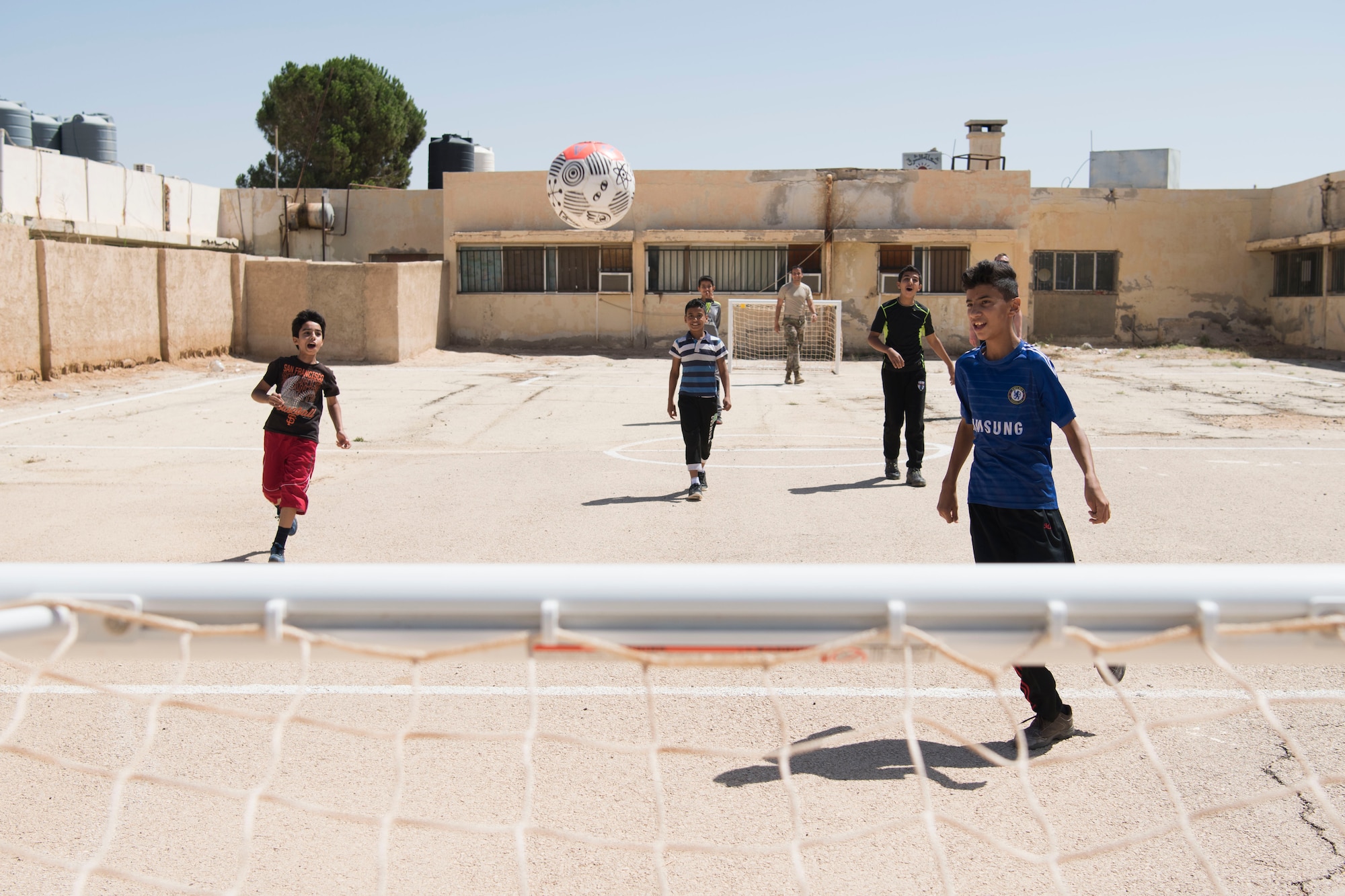 332nd Air Expeditionary Wing Airmen play soccer with local kids at an undisclosed location in Southwest Asia May 26, 2018. (U.S. Air Force photo by Senior Airman Krystal Wright)