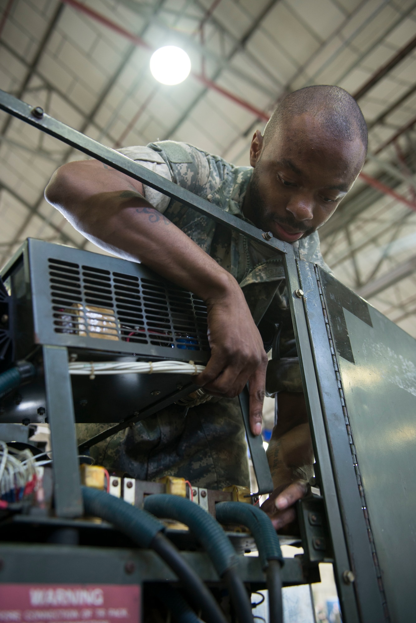 U.S. Air Force Senior Airman Lamar Cotton, 100th Maintenance Squadron aerospace ground equipment journeyman, fixes a diesel generator’s damaged power plane by replacing a damaged harness at RAF Mildenhall, England, May 8, 2018. AGE technicians use ground power to ensure the Bloody Hundredth’s KC-135 Stratotankers are ready to provide the critical air refueling "bridge" that allows the ARW to deploy and project airpower around the globe at a moment's notice. (U.S. Air Force photo by Airman 1st Class Alexandria Lee)