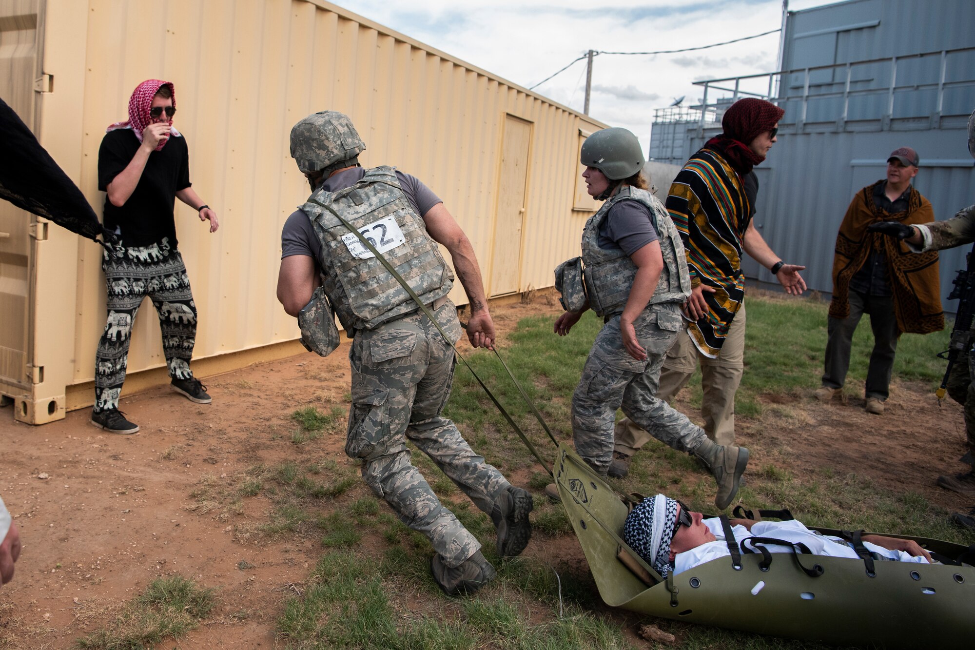 A medical technician from RAF Lakenheath, England, pulls a simulated wounded victim behind him during the Emergency Medical Technician Rodeo at Melrose Air Force Range, N.M., August 8, 2018. A total of 21 Air Force bases from around the world visited MAFR and Cannon Air Force Base, New Mexico, to participate in the EMT Rodeo, giving the technicians a wide assortment of scenarios to test their knowledge and training in the medical field. (U.S. Air Force photo by Airman 1st Class Gage Adison Daniel)