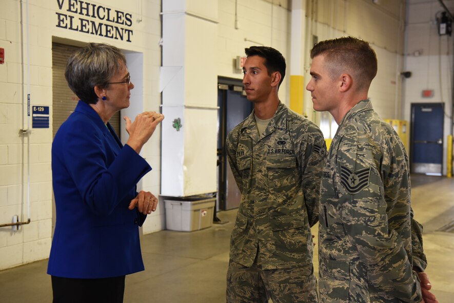 Secretary of the Air Force Heather Wilson speaks to Senior Airman Christopher Pilla, 90th Munitions Squadron nuclear weapons team member and Tech. Sgt. Evan McLelland, 90th Munitions Squadron nuclear weapons bay chief, during her tour Aug. 8, 2018, at F.E. Warren Air Force Base, Wyo. Pilla and McLelland were winners of the 90th Missile Wing’s Innovation Fund and were discussing their idea of repaving the indoor track and banking the edges to help Airmen on base. Wilson visited the base to emphasize the importance of the wing’s deterrence mission and to thank the Airmen for ensuring it is accomplished safely, securely and effectively every day. (U.S. Air Force photo by Senior Airman Breanna Carter)