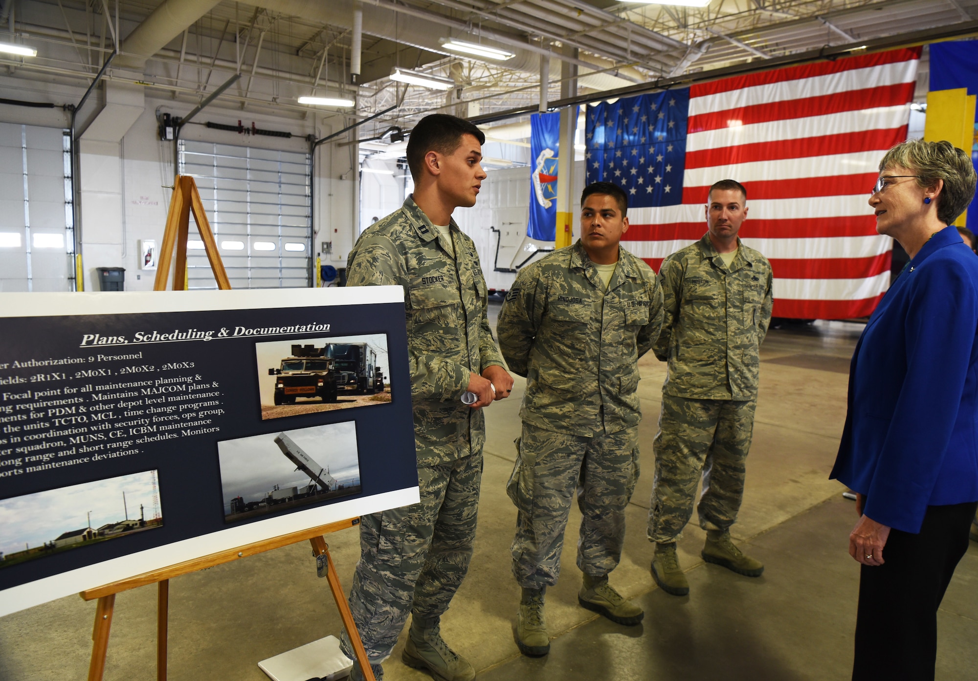 Secretary of the Air Force Heather Wilson listens intently to Capt. Cody Stocker, 790th Maintenance Squadron operations flight commander, during her tour Aug. 8, 2018, at F.E. Warren Air Force Base, Wyo. Stocker was discussing the manpower of the 90th Maintenance Group, and how they use their critical resources to effectively complete their mission. Wilson visited the base to emphasize the importance of the wing’s deterrence mission and to thank the Airmen for ensuring it is accomplished safely, securely and effectively every day. (U.S. Air Force photo by Senior Airman Breanna Carter)