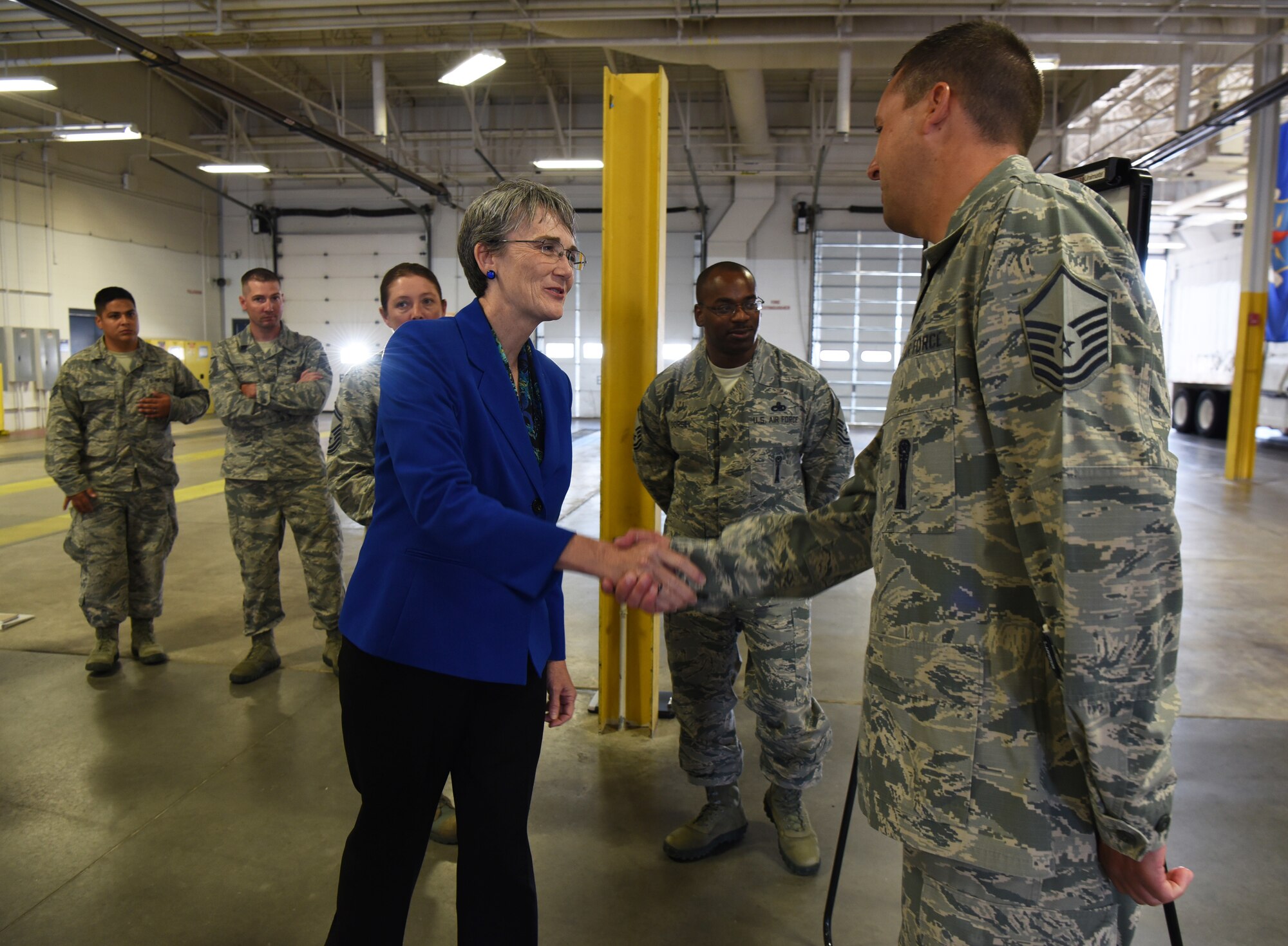 Secretary of the Air Force Heather Wilson shakes hands with Master Sgt. Chad Trageser, 790th Maintenance Squadron production superintendent, during her tour Aug. 8, 2018, at F.E. Warren Air Force Base, Wyo. Wilson stopped by the 90th Maintenance Group building to speak with the 90th Missile Wing’s Innovation Fund winners. Trageser’s idea is to build an explosive ordinance disposal training site on base. Wilson visited the base to emphasize the importance of the wing’s deterrence mission and to thank the Airmen for ensuring it is accomplished safely, securely and effectively every day. (U.S. Air Force photo by Senior Airman Breanna Carter)