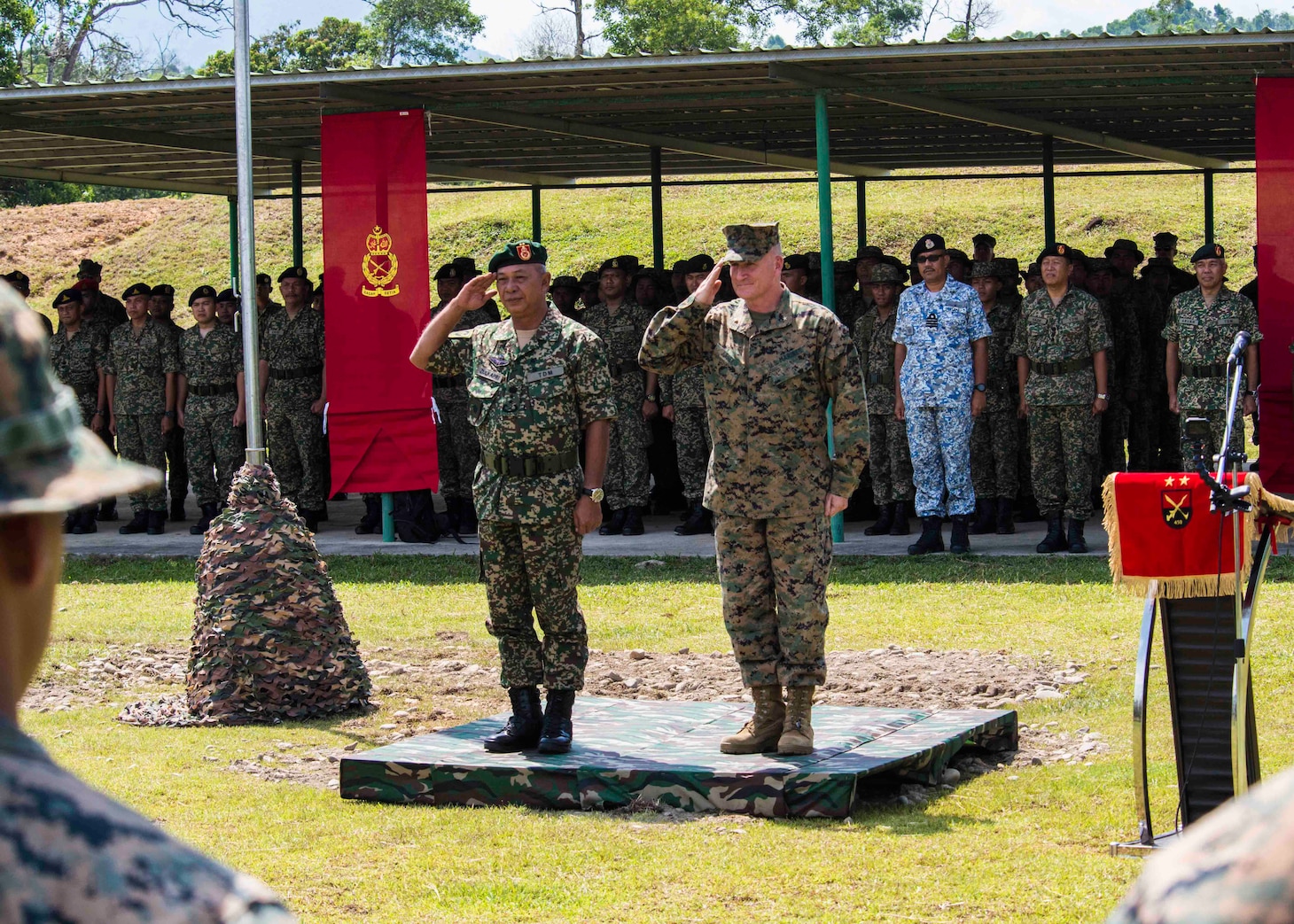 KOTA KINABALU, Malaysia (August 10, 2018) - Brig. Gen. William Jurney, Commanding General of 3rd Marine Infantry Division, and Maj. Gen. Dato� Zulkapri bin Rahamat, General of Officer Commanding Task Force 450, render salutes during the opening ceremony of Cooperation Afloat Readiness and Training (CARAT) Malaysia on Kota Belud Marine Base. CARAT Malaysia in its 24th iteration, is designed to enhance information sharing and coordination, build mutual warfighting capability and support long-term regional cooperation enabling both partner armed forces to operate effectively together as a unified maritime force.