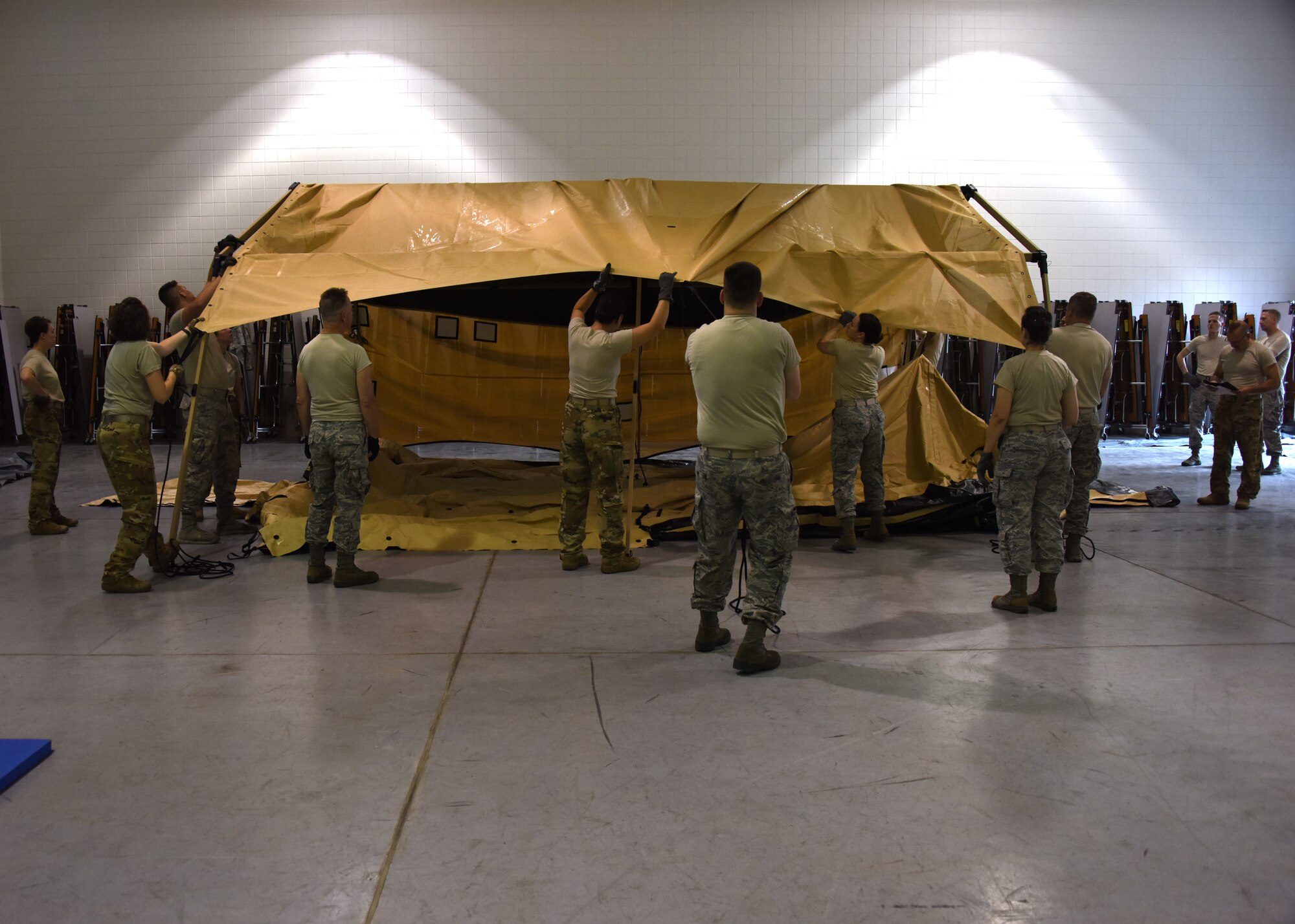 Airmen from the Aeromedical Staging Squadron and the Aeromedical Evacuation Squadron at the Pittsburgh International Airport Air Reserve Station, pull a rain cover over the tent frame at Camp Dawson, West Virginia June 20, 2018. This was the second build of the tent throughout the day but it was the first time they had used the rain cover.(U.S. Air Force Photo by Senior Airman Grace Thomson)