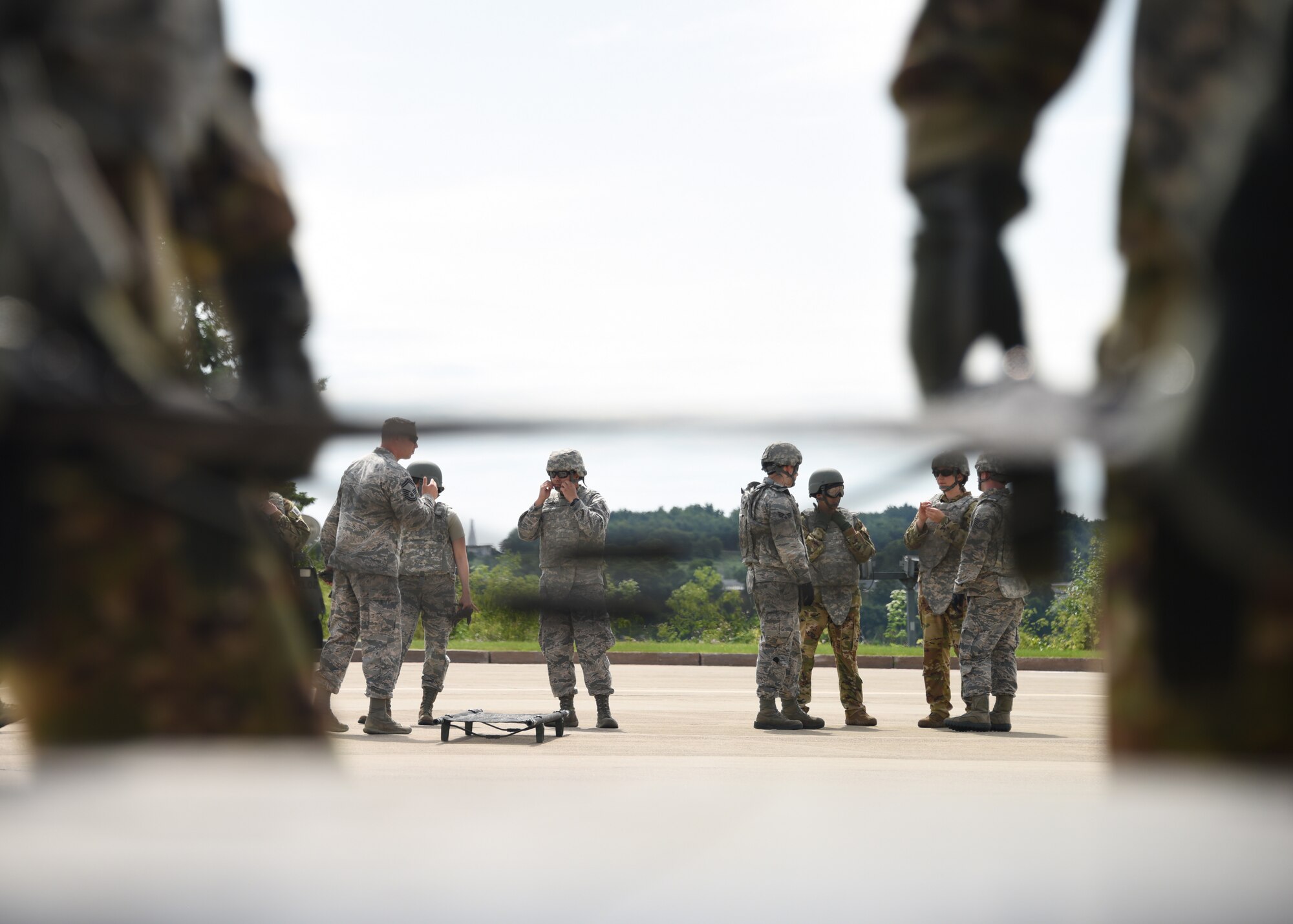 Members of the Pittsburgh International Airport Air Reserve Station Aeromedical Staging Squadron and Aeromedical Evacuation Squadron take part in training on a Blackhawk helicopter at the Pittsburgh International Airport Air Reserve Station, Pennsylvania, June 26, 2018. This training was to learn how to load and unload patients from a medical evacuation helicopter during a combat situation. (U.S. Air Force Photo by Senior Airman Grace Thomson)