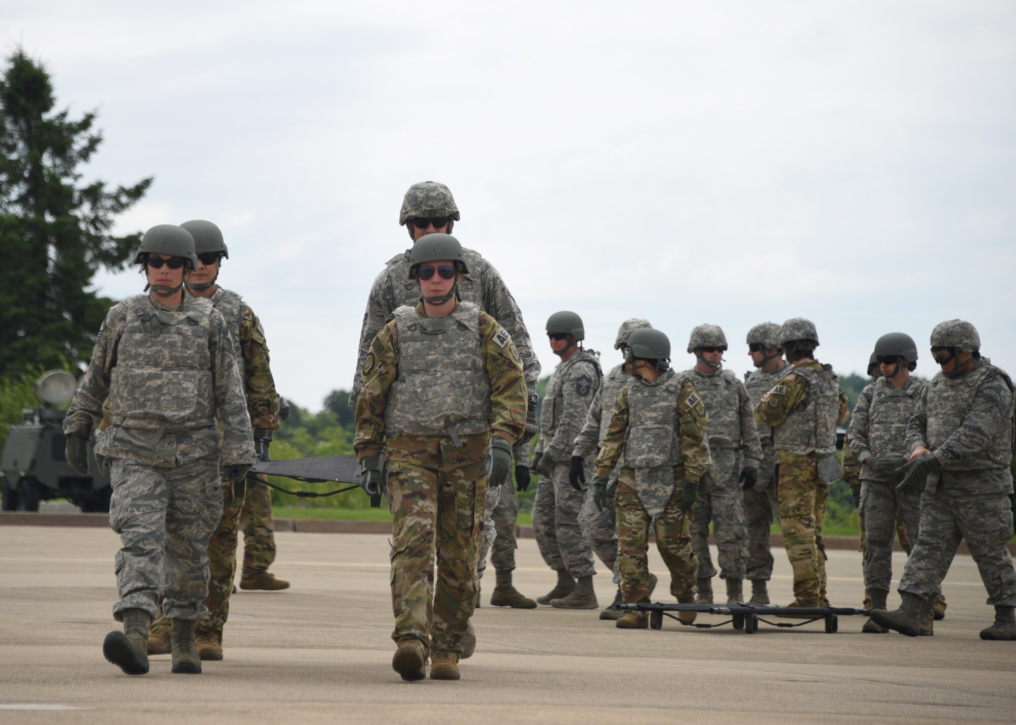 Members of the Pittsburgh International Airport Air Reserve Station Aeromedical Staging Squadron and Aeromedical Evacuation Squadron carry a stretcher to a helicopter at the Pittsburgh International Airport Air Reserve Station, Pennsylvania, June 26, 2018. Members form both squadrons worked together during this exercise and learned more about each other in the process. (U.S. Air Force Photo by Senior Airman Grace Thomson)