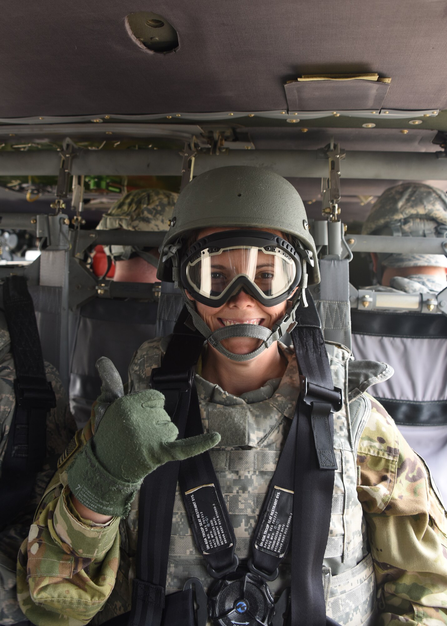 Capt. Sarah May, a flight nurse with the Aeromedical Evacuation Squadron at the Pittsburgh International Airport Air Reserve Station poses for a photo during a helicopter ride at the Pittsburgh International Airport Air Reserve Station, Pennsylvania, June 26, 2018. All members of the AES as well as the Aeromedical Staging Squadron got a chance to ride in a Blackhawk helicopter during the training.(U.S. Air Force Photo by Senior Airman Grace Thomson)