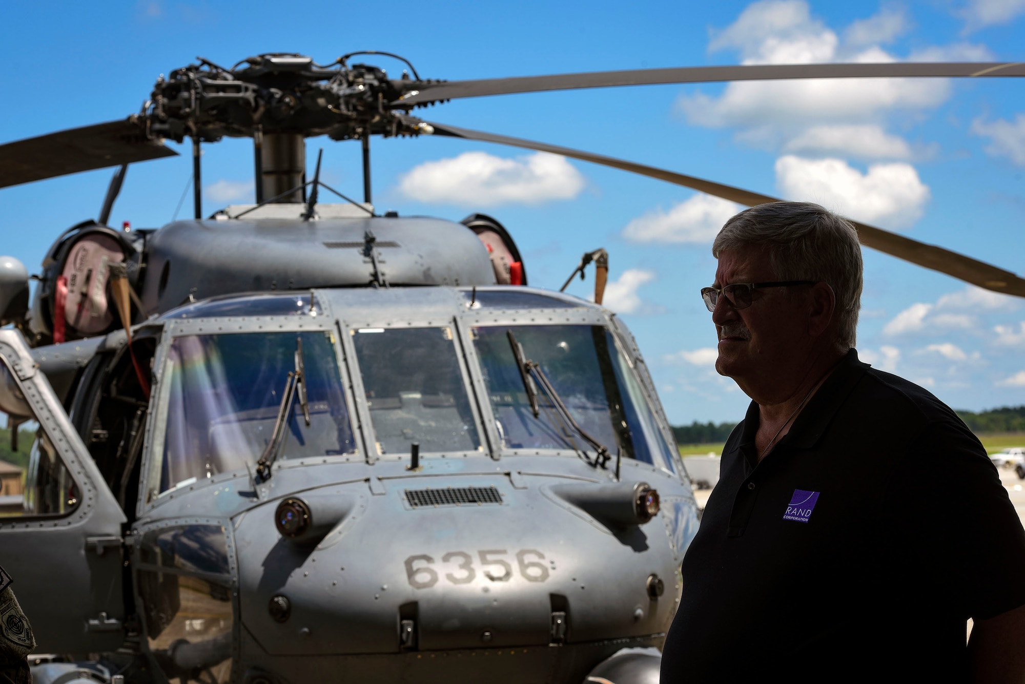 John Drew, RAND Corporation senior defense analyst, stands in front of an HH-60G Pave Hawk during a visit, Aug. 7, 2018, at Moody Air Force Base, Ga. RAND integrated with Moody’s rescue, flying and maintenance professionals to examine firsthand Air Force operations. This familiarization helps RAND develop their analysis to ultimately present policy recommendations to Air Force decision makers. Since 1948, RAND has performed analysis for the U.S. Air Force. (U.S. Air Force photo by Senior Airman Greg Nash)
