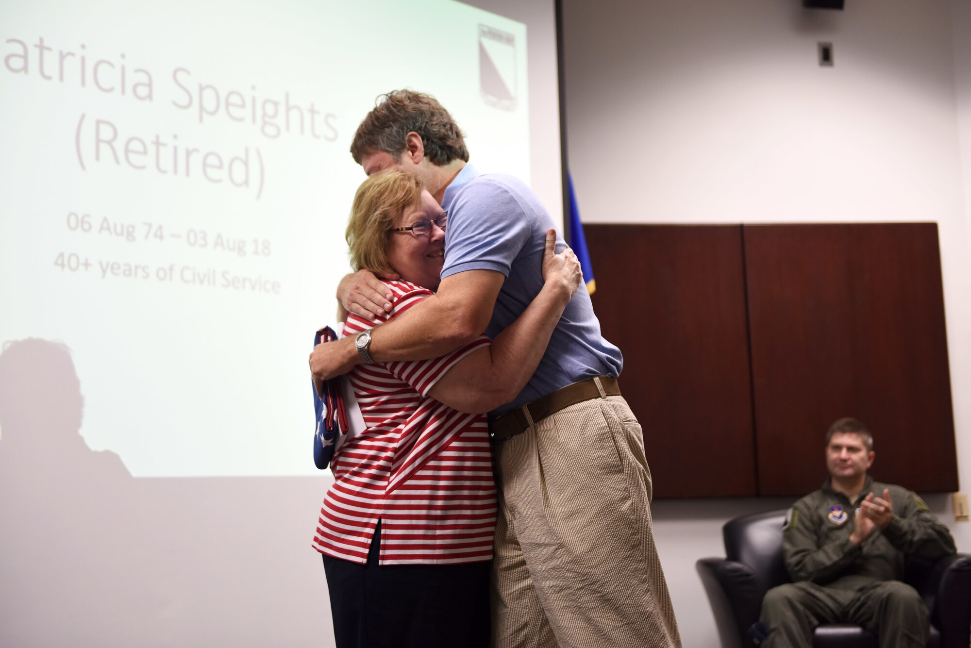Patricia Speights, former 14th Operations Group secretary, hugs her son, Jamie, after presenting him with an American flag Aug. 3, 2018, on Columbus Air Force Base, Mississippi. Speights and her family served the Air Force for 40 years. (U.S. Air Force photo by Airman 1st Class Beaux Hebert)