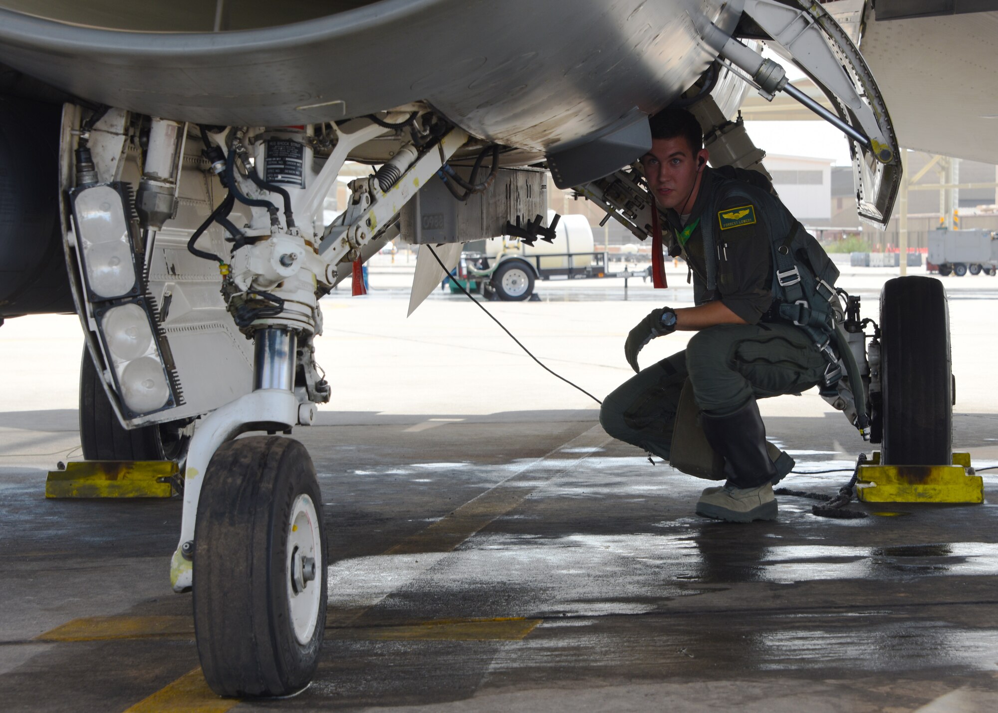 U.S. Air Force 1st Lt. Robert Lowery, a 310th Fighter Squadron F-16 Fighting Falcon student pilot, checks his landing gear before flight Aug. 8, 2018 at Luke Air Force Base, Ariz.