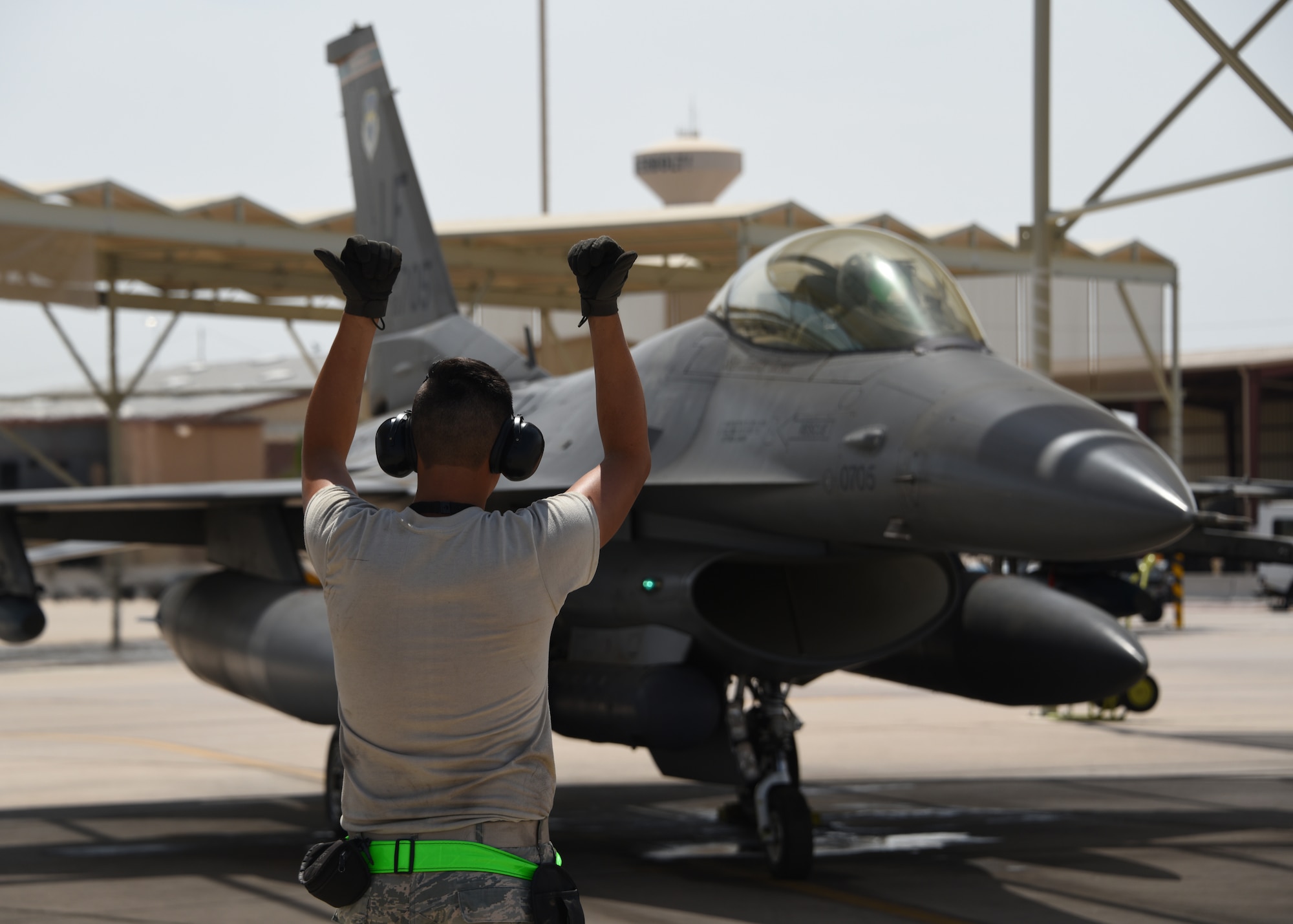 U.S. Air Force Airman 1st Class Joseph Jensen, 310th Aircraft Maintenance Unit maintainer, signals that the chocks are pulled, Aug. 8, 2018 at Luke Air Force Base, Ariz.
