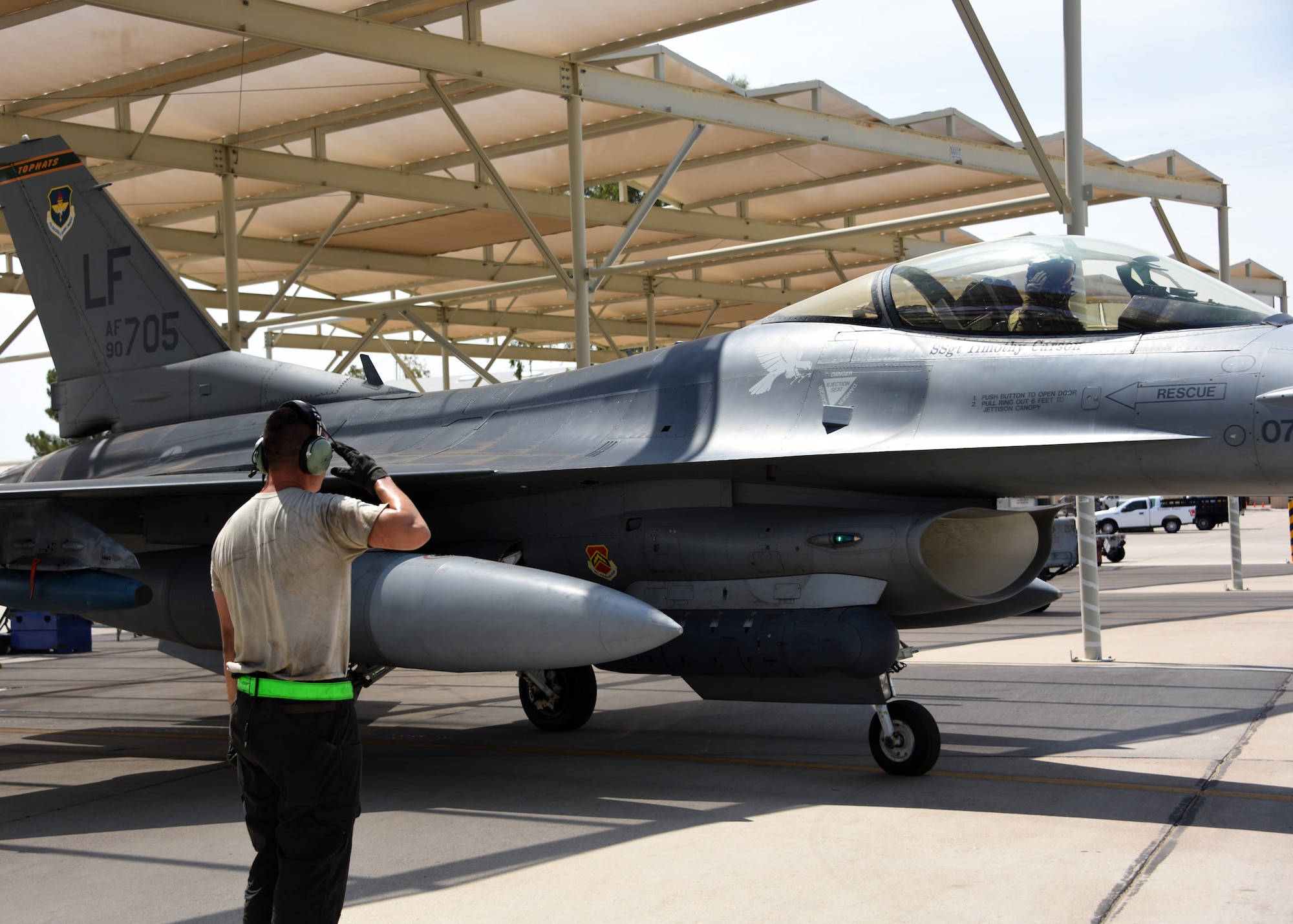 A crew chief from the 310th Aircraft Maintenance Unit, salutes 1st Lt. Robert Lowery, an F-16 Fighting Falcon student pilot, as he taxis to the runway, Aug. 8, 2018 at Luke Air Force Base, Ariz.