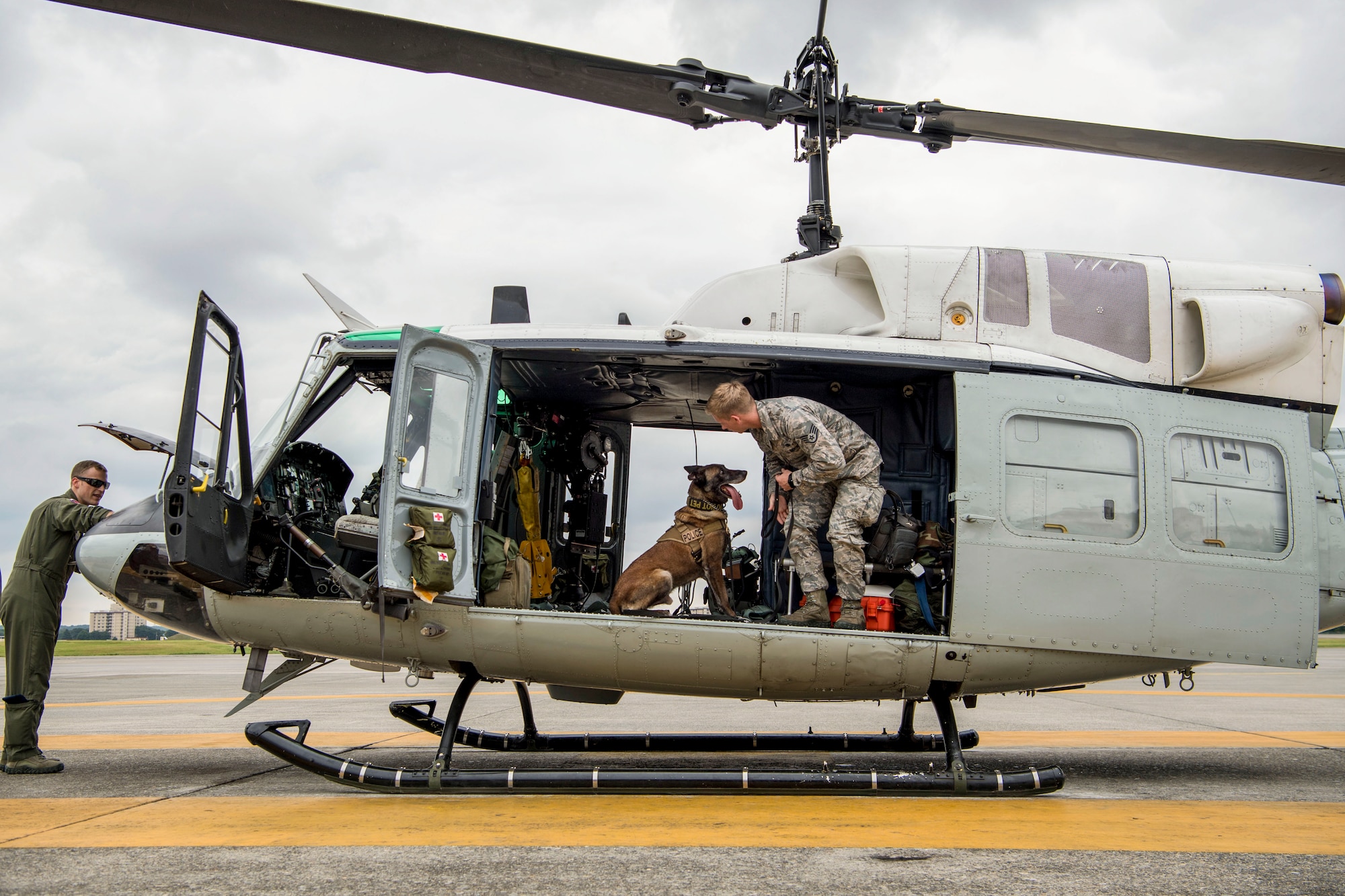 Staff Sgt. Cody Nickell, 374th Security Forces Squadron military working dog handler, works with Topa, 374th SFS MWD, to get him accustomed to being inside a UH-1N helicopter during a 459th Airlift Squadron MWD familiarization flight July 26, 2018, at Yokota Air Base, Japan. Flying in a helicopter can be hard for the MWD’s due to the noise and vibrations, but once the MWDs become comfortable with the aircraft, they can be transported quickly and efficiently to wherever needed. (U.S. Air Force photo by Senior Airman Donald Hudson)