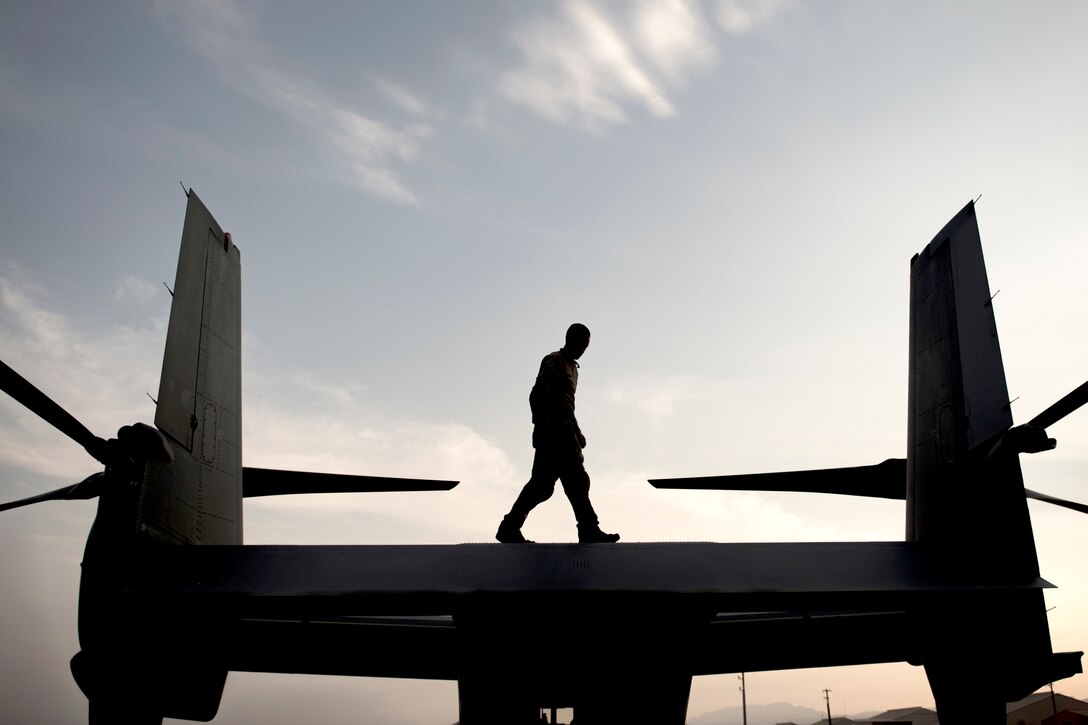 Tech. Sgt. Jared Rogness, a flight engineer with the 20th Special Operations Squadron at Cannon Air Force Base, N.M., walks atop a CV-22 Osprey tiltrotor aircraft during Red Flag 18-3 at Nellis AFB, Nev., July 31, 2018. The primary function of a CV-22 is to conduct long-range infiltration, exfiltration and resupply missions for special operations forces. (U.S Air Force photo by Airman 1st Class Andrew D. Sarver)