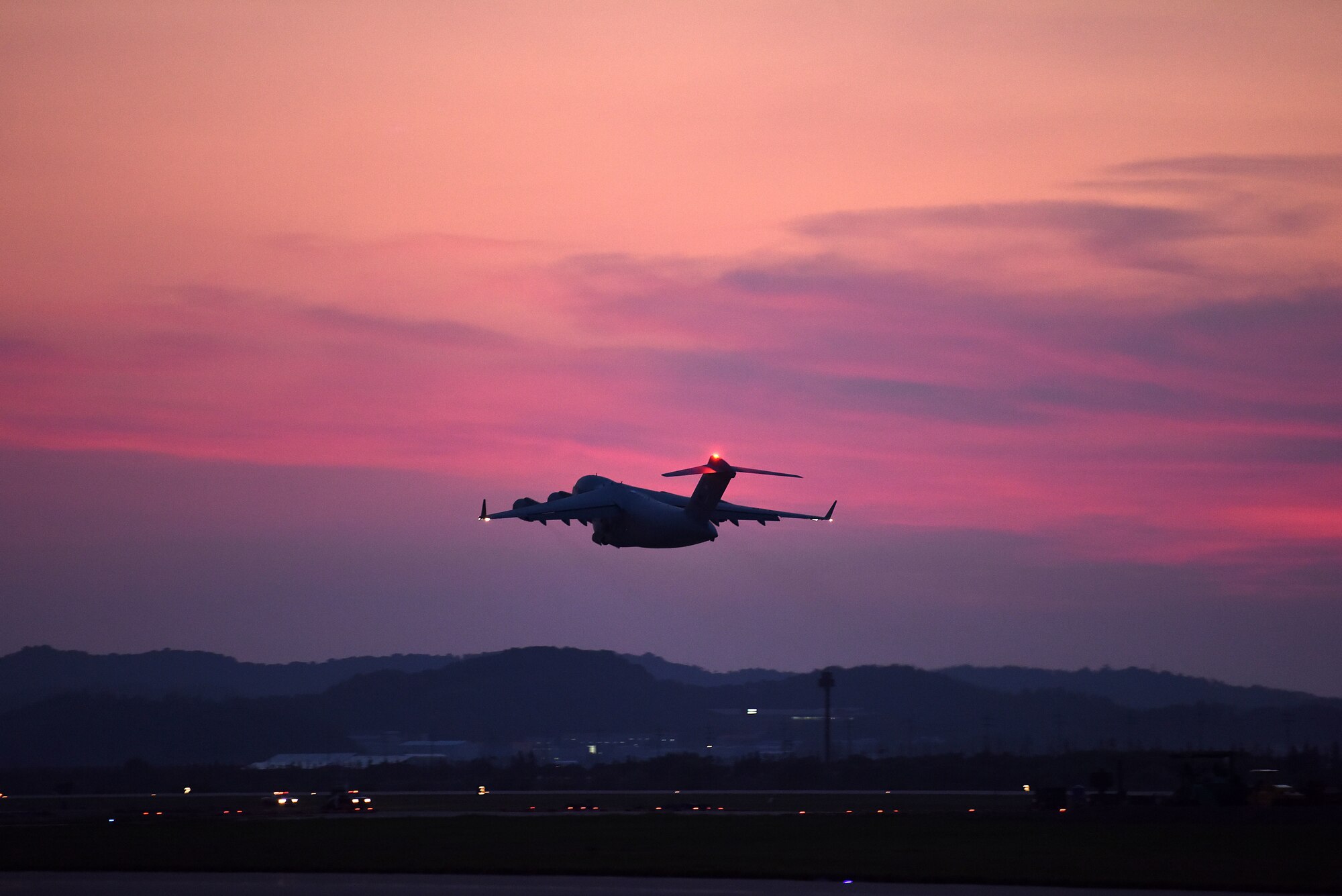 A C-17 Globemaster III, carrying dignified transfer cases containing fallen service members, takes off from Osan Air Base, South Korea, Aug. 1, 2018, en route to Joint Base Pearl Harbor-Hickam, Hawaii, where members of the Defense POW Accounting Agency will attempt to identify the remains. The remains of 55 cases were repatriated from North Korea. (U.S. Air Force photo by Senior Airman Kelsey Tucker)
