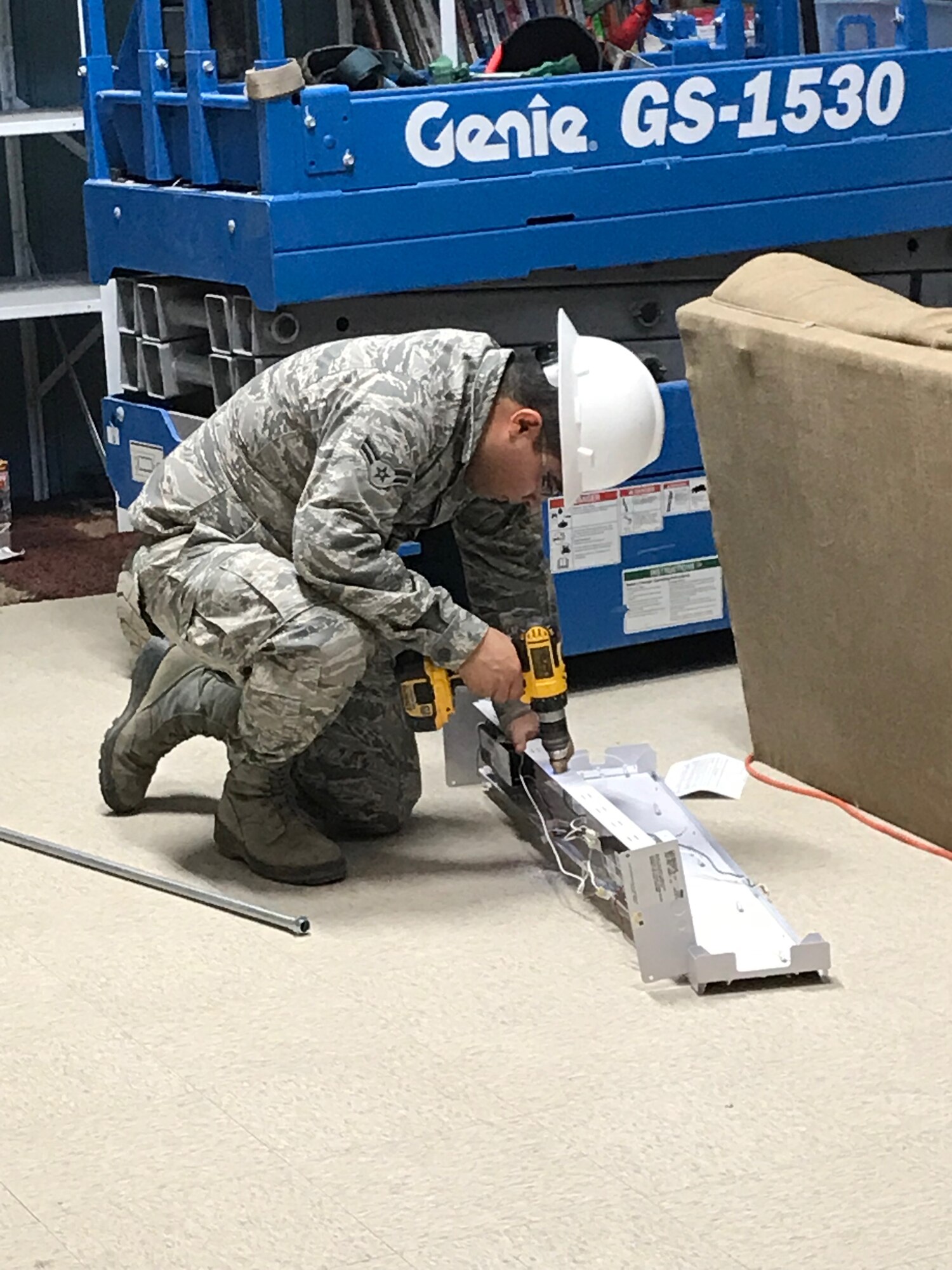 An Airman from the 49th Civil Engineer Squadron repairs a light fixture during the renovation of building 232. (Courtesy photo)
