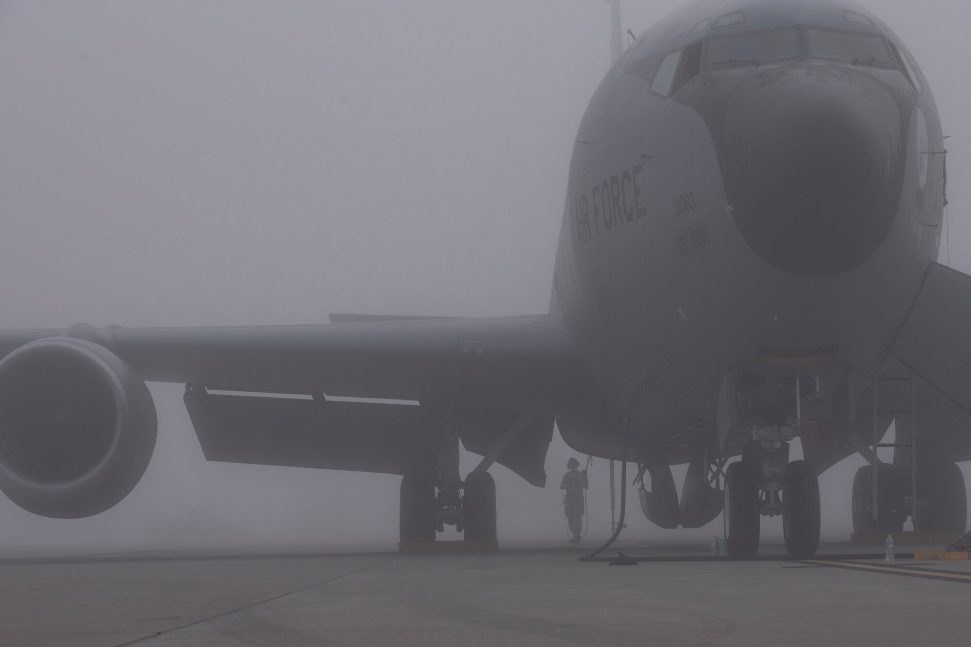 Airmen with the 121st Air Refueling Wing, work on a KC-135 Stratotanker in thick fog at Rickenbacker Air National Guard Base, Ohio, Aug. 3, 2018. Airmen stayed visible during the inclement weather by wearing their reflective belts. (U.S. Air National Guard photo by Airman 1st Class Tiffany A. Emery)