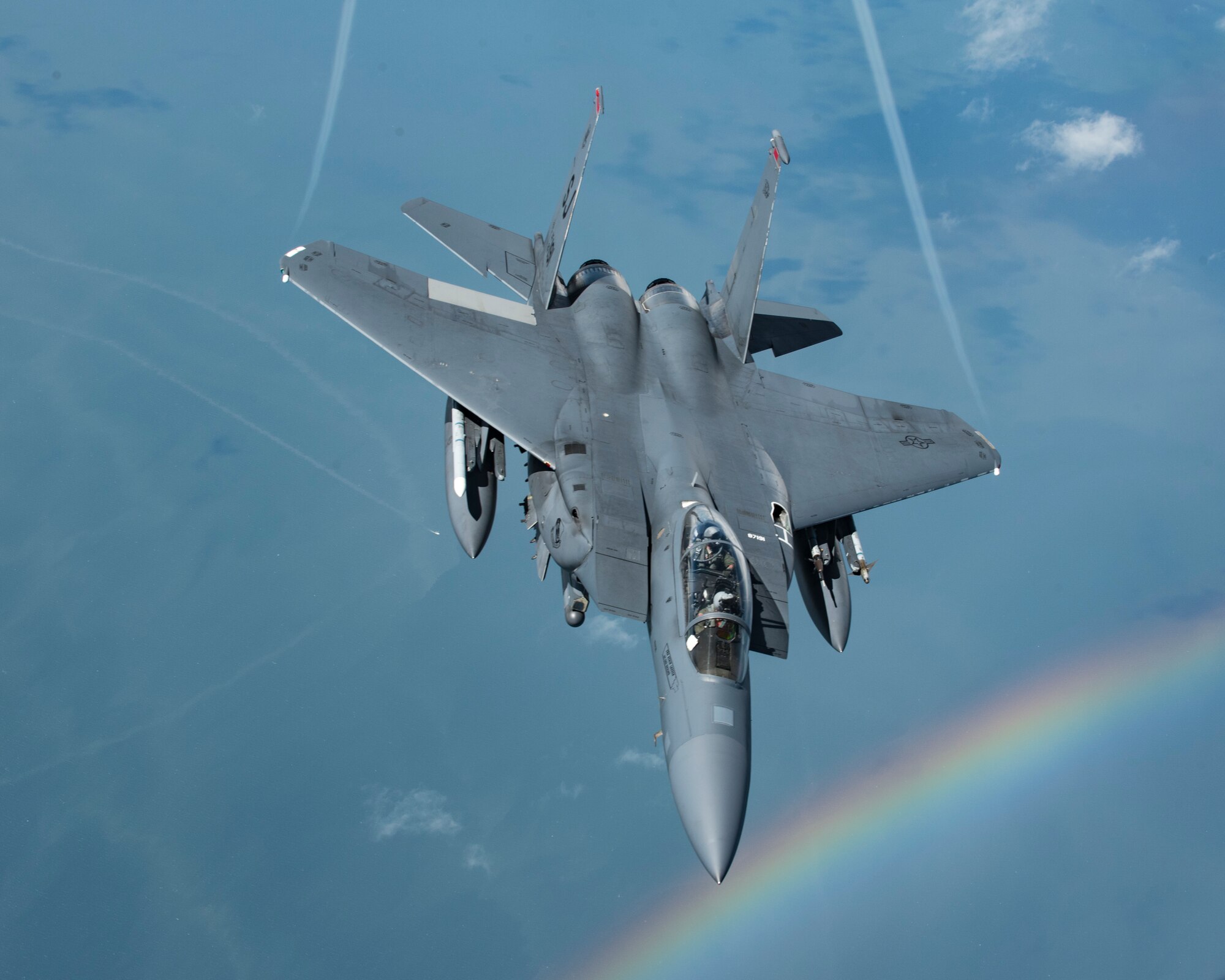 An F-15E Strike Eagle with the 4th Fighter Wing at Seymour Johnson Air Force Base, N.C., flies near a rainbow over the southeastern U.S. Aug. 8, 2018. The Strike Eagle had just been refueled by a KC-135 Stratotanker with the 121st Air Refueling Wing out of Ohio. (U.S. Air National Guard photo by Airman 1st Class Tiffany A. Emery)