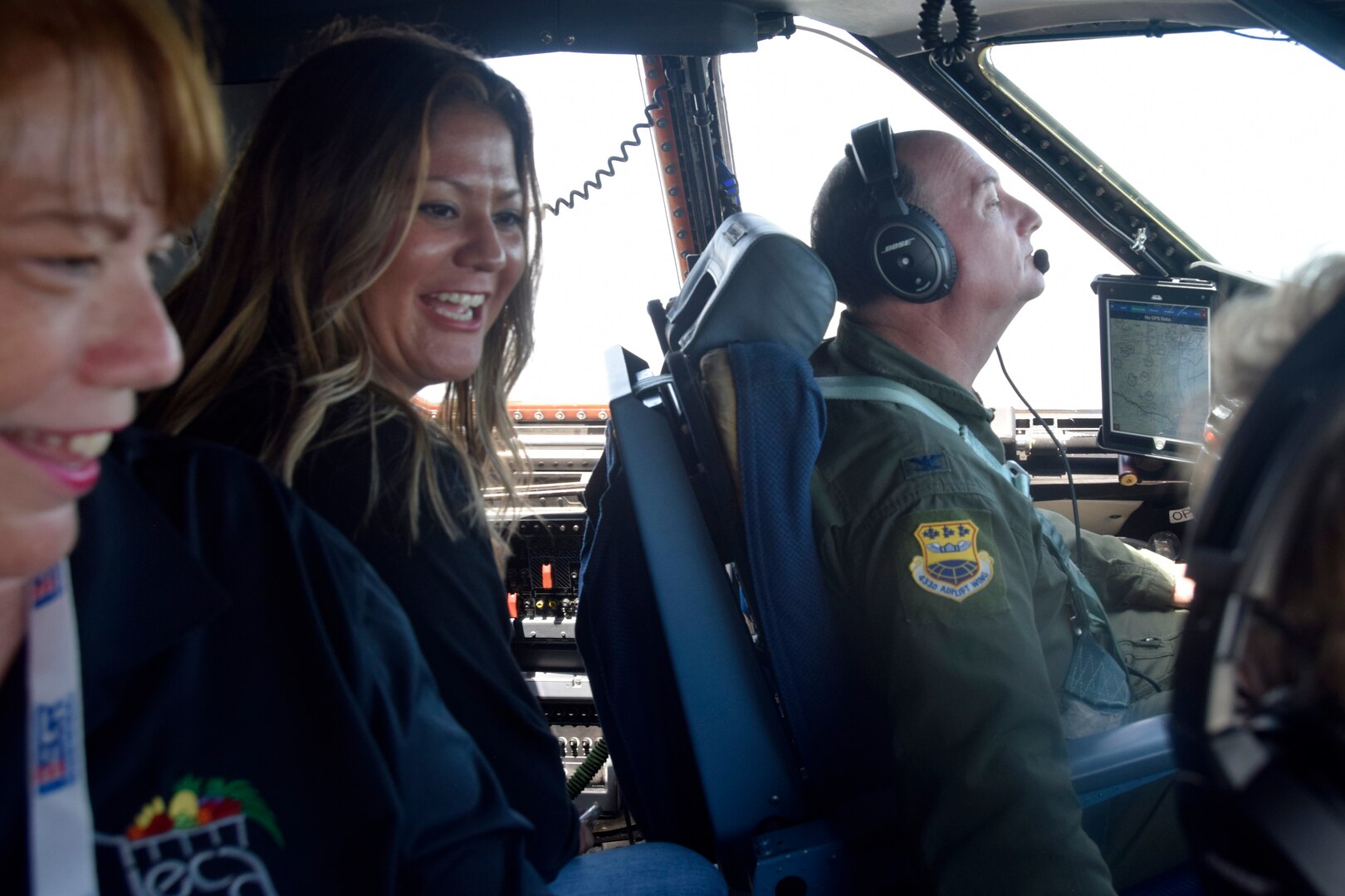 Civilian employers aboard a C-5M Super Galaxy aircraft talk with the pilots during an Operation Bosslift flight from Joint Base San Antonio-Lackland, Texas, Aug. 4, 2018. The 433rd Airlift Wing manages, maintains and trains Air Force Reserve personnel to support peacetime missions and Air Expeditionary Force tasking compatible with Air Force Reserve Command training requirements and maintenance of mobilization readiness. (U.S. Air Force photo by Staff Sgt. Lauren M. Snyder)