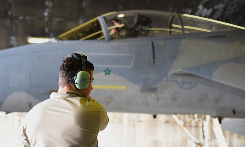 An Airman assigned to the 748th Aircraft Maintenance Squadron prepares to marshal an F-15C Eagle at Keflavik Air Base, Iceland, Aug. 1, 2018, in support of NATO’s Icelandic Air Surveillance mission. More than 250 U.S. Air Forces in Europe-Air Forces Africa Airmen and 14 F-15C/D Eagles deployed from Royal Air Force Lakenheath, England, with additional support from U.S. Airmen assigned to Aviano Air Base, Italy. (U.S. Air Force photo/Staff Sgt. Alex Fox Echols III)