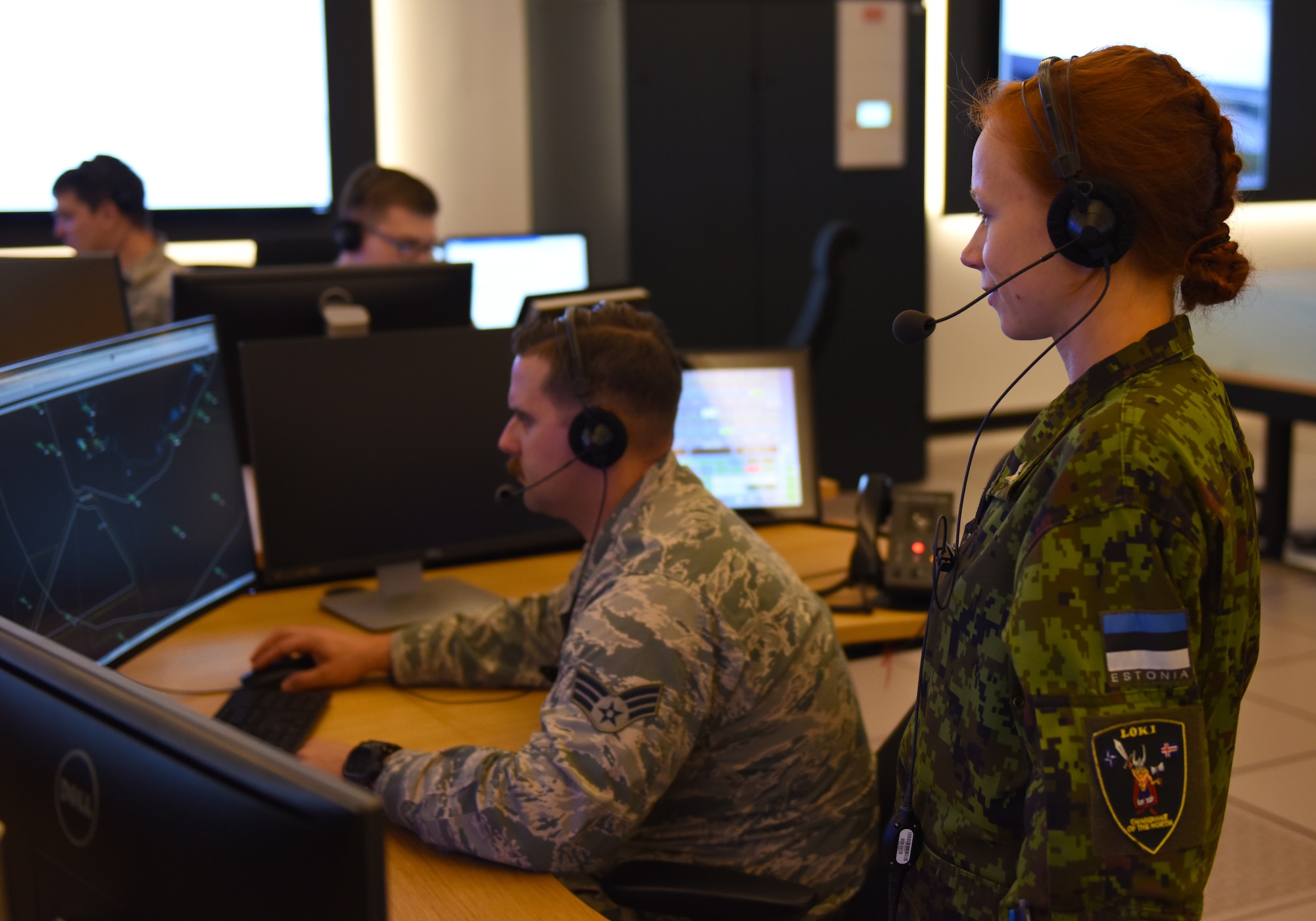 U.S. Air Force and Estonian military personnel work together in the Control and Reporting Center at Keflavik Air Base, Iceland, Aug. 3, 2018 in support of NATO’s Icelandic Air Surveillance mission. The CRC houses U.S. Airmen from the 606th Air Control Squadron from Aviano Air Base, Italy, personnel from the Estonian military and Icelandic Coast Guard members to watch the skies, dispatch an F-15 scramble should the need arise and aid the pilots with potential interception once they are in the air. (U.S. Air Force photo/Staff Sgt. Alex Fox Echols III)
