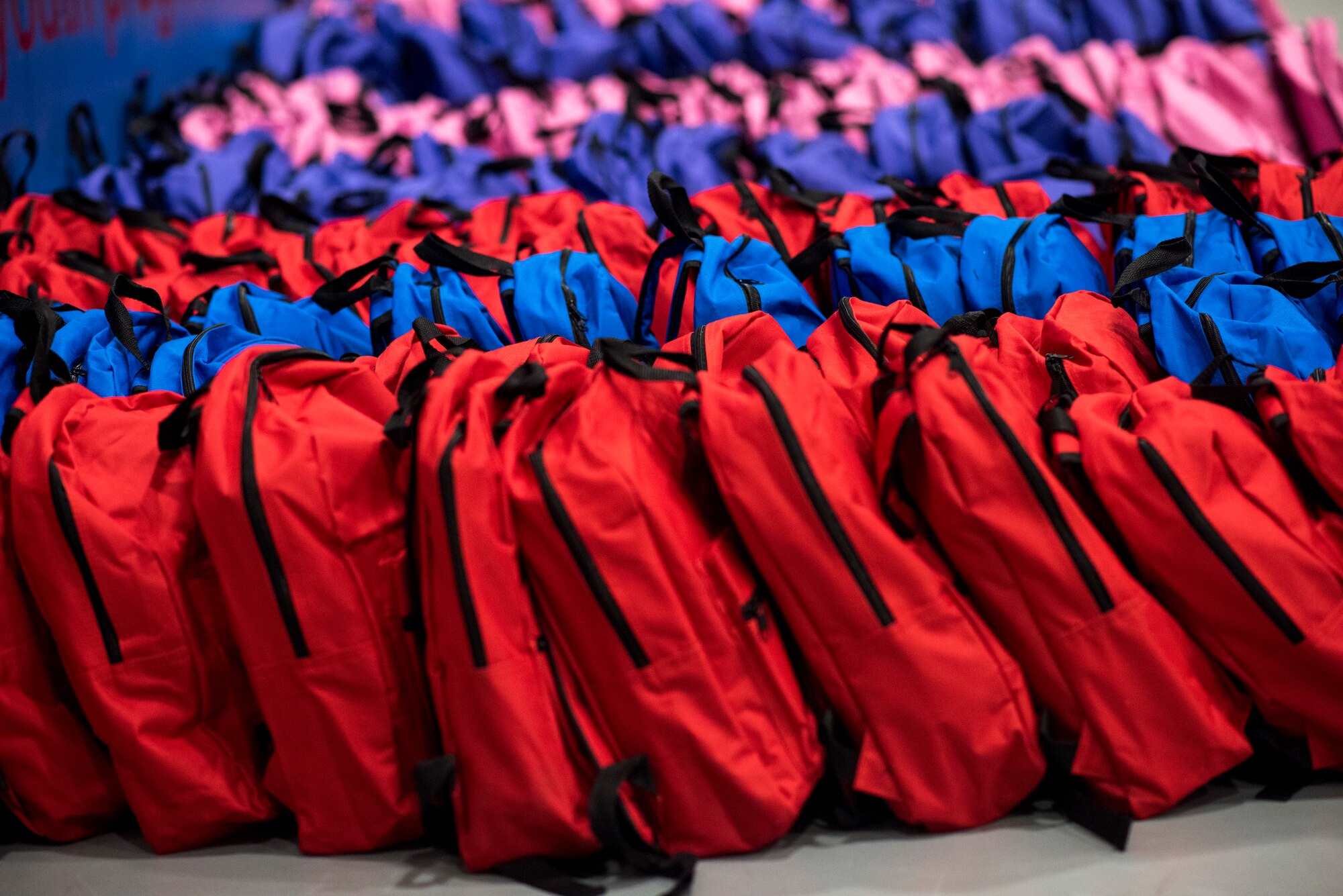 Backpacks filled with back to school supplies line the floor of the Youth Center at Mountain Home Air Force Base, Idaho, Aug. 4, 2018. 200 backpacks were packed with supplies and handed out to school age military children.