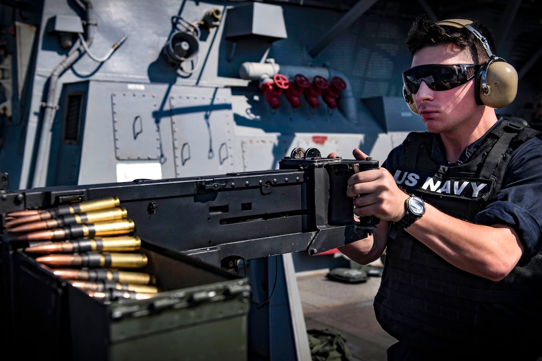 A sailor fires a .50-caliber machine gun during live-fire training.