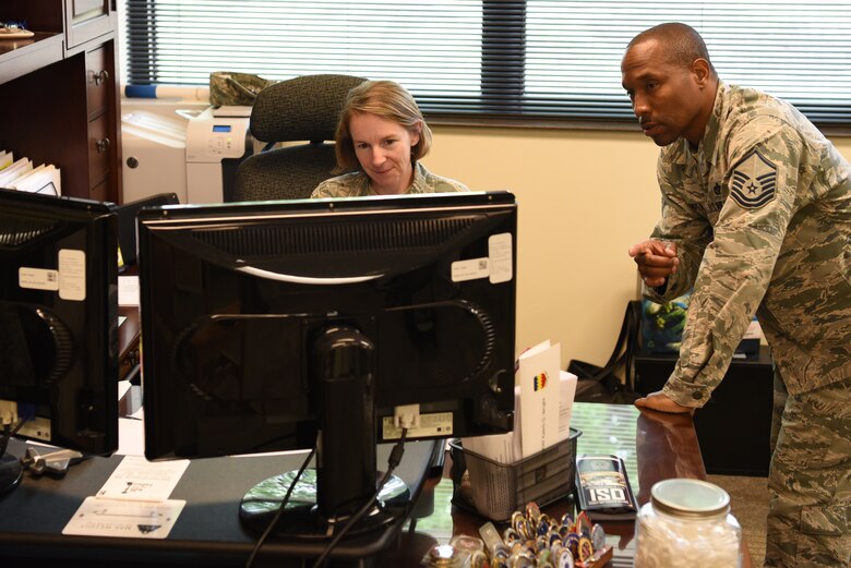 U.S. Air Force Senior Master Sgt. Brandy Hill, left, and Master Sgt. Jamell Camper, right, 20th Force Support Squadron career assistance advisors (CAA), review records at Shaw Air Force Base, S.C., Aug. 3, 2018.