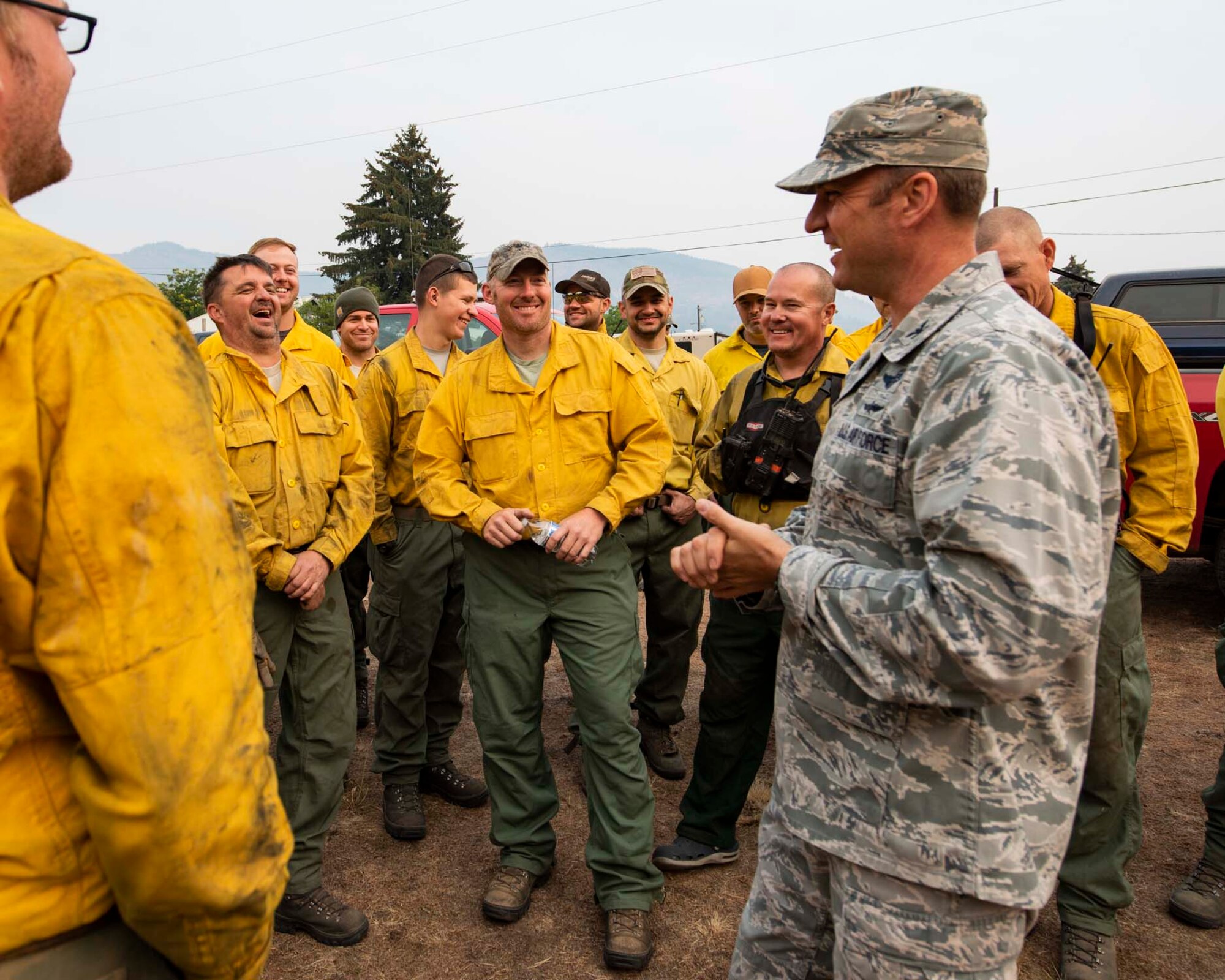 Col. Johan Deutscher, commander of the 141st Air Refueling Wing, greets guardsmen from the 141st who mobilized to Northport, Wash. to support firefighting efforts for the Sheep Creek fire August 8, 2018. Nearly 60 Guardsmen from the 141st ARW were mobilized to help support firefighting efforts throughout the region. (U.S. Air National Guard photo by Staff Sgt. Rose M. Lust)