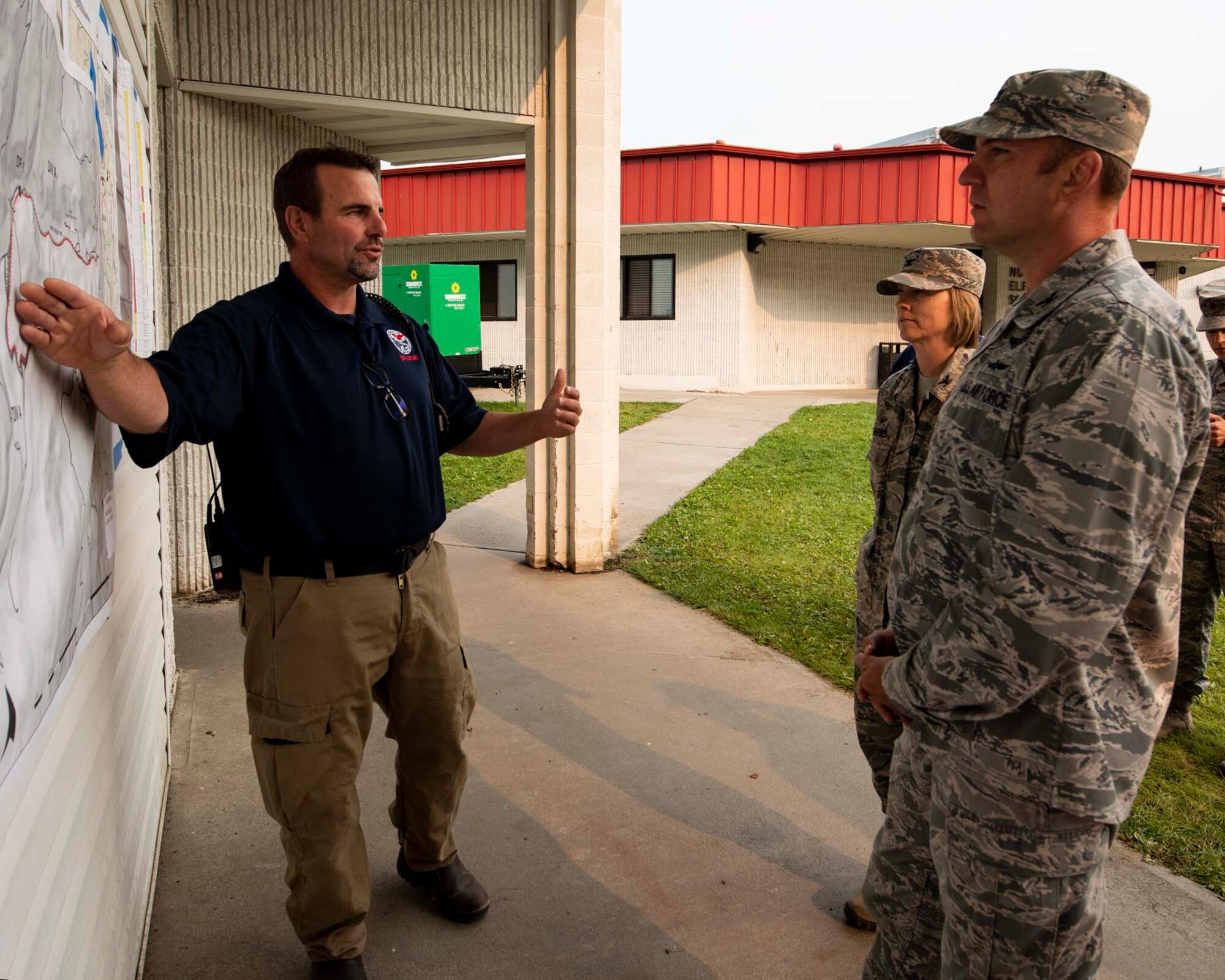 Andrew Stenbeck, the incident commander at the Sheep Creek fire camp, briefs Col. Johan Deutscher, commander of the 141st Air Refueling Wing, on the incident action plan for the Sheep Creek fire in Northport, Wash. August 8, 2018. Nearly 60 Guardsmen from the 141st ARW were mobilized to help support firefighting efforts throughout the region. (U.S. Air National Guard photo by Staff Sgt. Rose M. Lust)