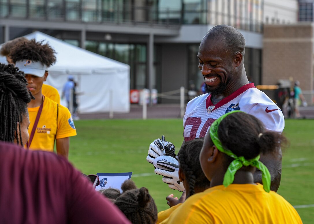 Vernon Davis, Washington Redskins tight end, autographs memorabilia during their training camp in Richmond, Virginia, August 7, 2018.