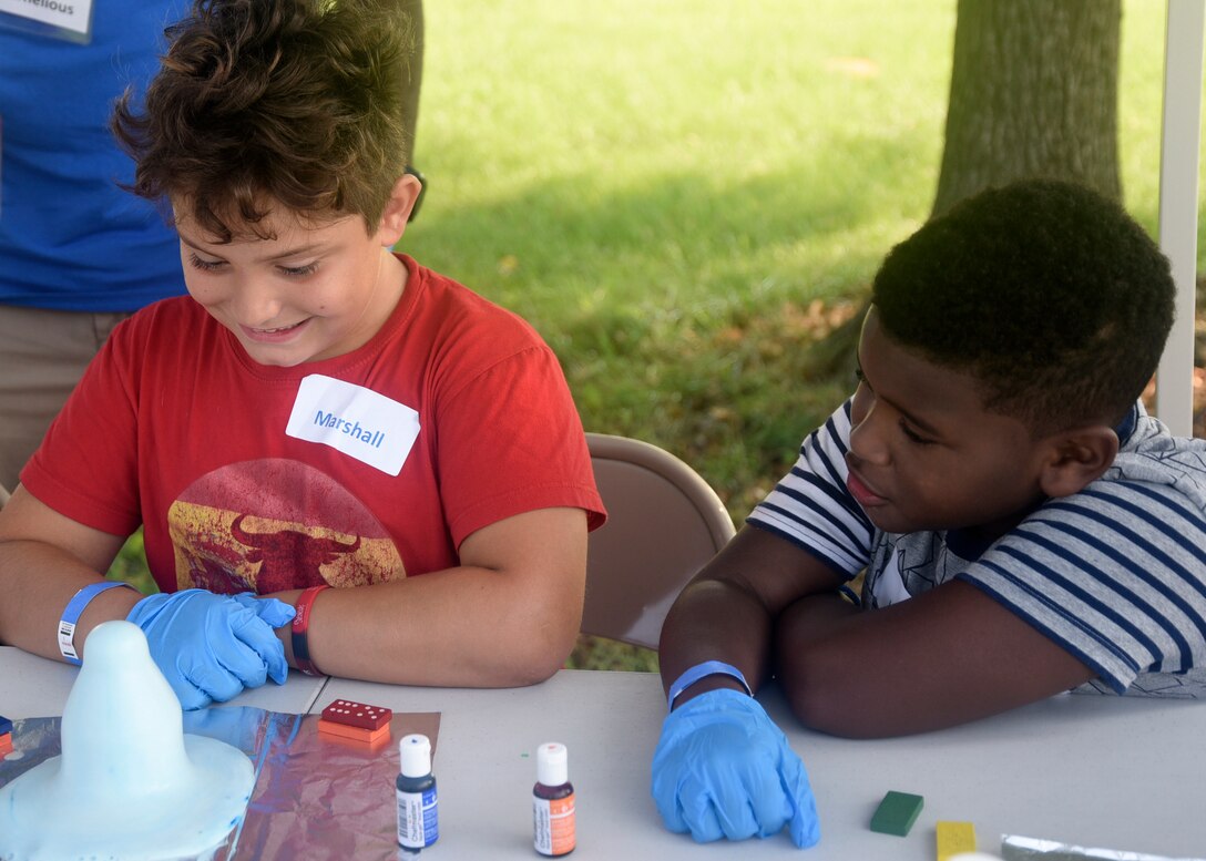 Marshall Stuckey, left, and Jaylen Pitter take part in a science experiment during the 7th Annual Exceptional Family Member Program Summer Camp Experience at Joint Base Andrews, Md., Aug. 7, 2018. Camp attendees were special-needs military dependent children enrolled in EFMP and their siblings. (U.S. Air Force photo by Senior Airman Abby L. Richardson)