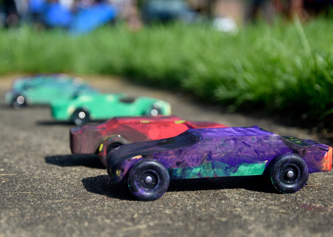 Painted derby cars are left in the sun to dry during the 7th Annual Exceptional Family Member Program Summer Camp Experience at Joint Base Andrews, Md., Aug. 9, 2018. Camp attendees decorated and raced the cars as part of the weeklong STEM-based camp. (U.S. Air Force photo by Senior Airman Abby L. Richardson)