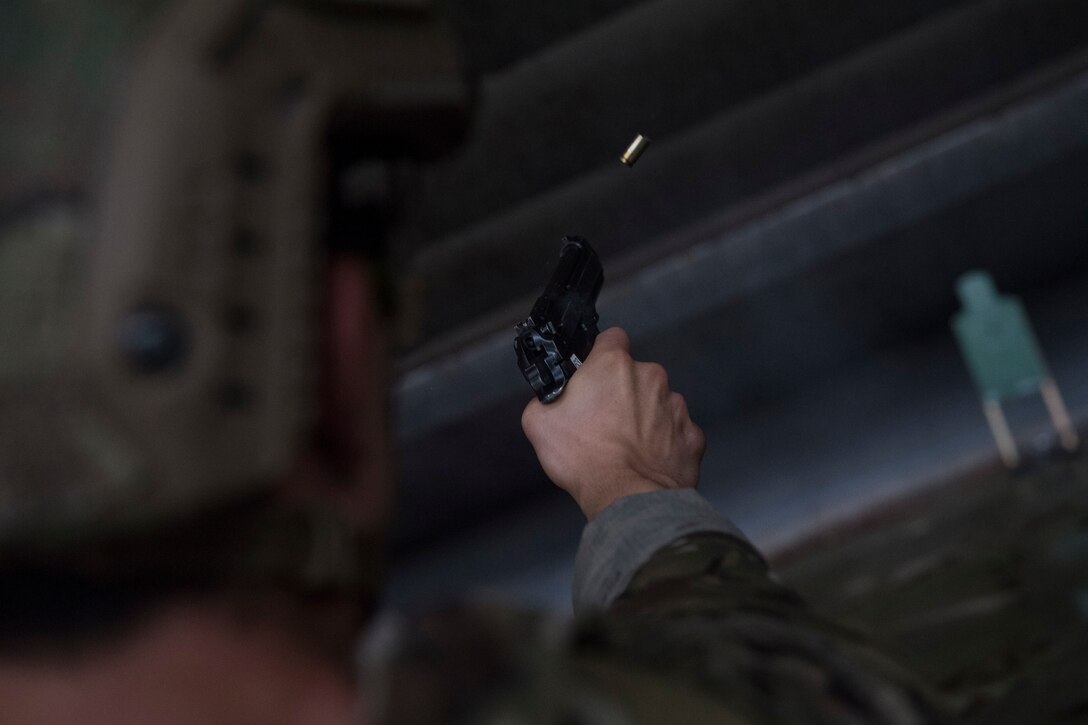 A joint terminal attack controller from the 18th Air Support Operations Group fires an M9 Beretta pistol during Draco Spear, Aug. 3, 2018, at Moody Air Force Base, Ga. Draco Spear is a revival of the mid-2000s joint-training event Dragon Challenge that tested the top JTACs from various air support operations squadrons both mentally and physically. (U.S. Air Force photo by Senior Airman Janiqua P. Robinson)