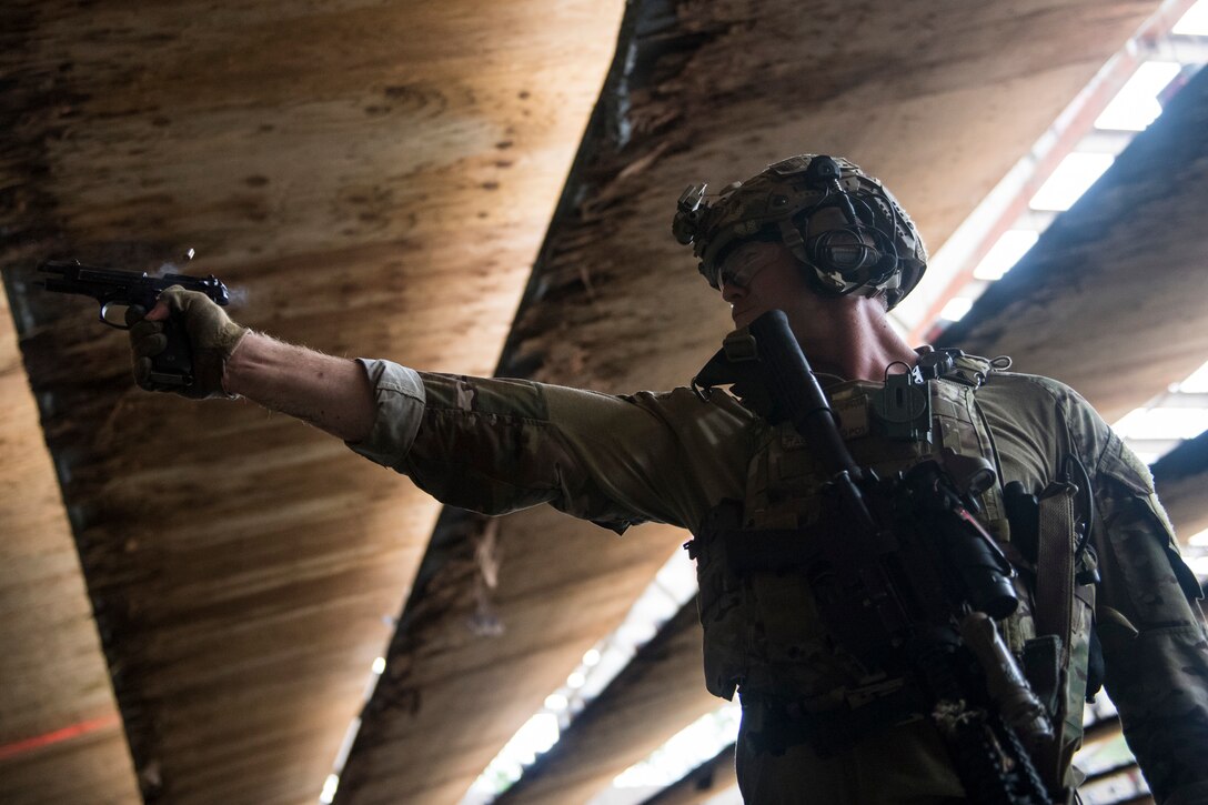 Tech. Sgt. Ryan Shipman, 19th Air Support Operations Squadron (ASOS) joint terminal attack controller (JTAC), fires an M9 Beretta pistol during Draco Spear, Aug. 3, 2018, at Moody Air Force Base, Ga. Draco Spear is a revival of the mid-2000s joint-training event Dragon Challenge that tested the top JTACs from various air support operations squadrons both mentally and physically. (U.S. Air Force photo by Senior Airman Janiqua P. Robinson)