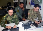 Soldiers from Colombia and the U.S. and an officer from the Panamanian National Police, work in the communications cell of the Combined Forces Land Component Command operations center at the Mission Training Complex at Joint Base San Antonio-Fort Sam Houston Aug. 8.