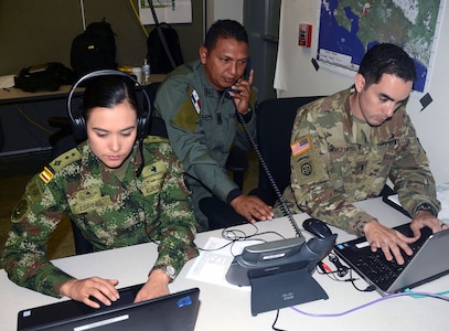 Soldiers from Colombia and the U.S. and an officer from the Panamanian National Police, work in the communications cell of the Combined Forces Land Component Command operations center at the Mission Training Complex at Joint Base San Antonio-Fort Sam Houston Aug. 8.