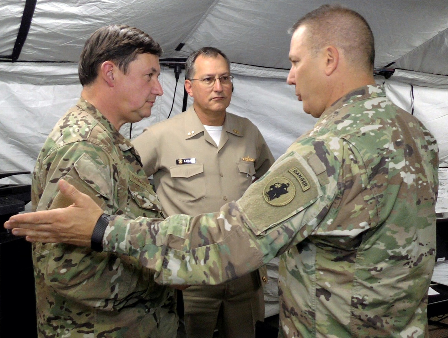 (Right to left) Maj. Gen Mark Stammer, commander, U.S. Army South; Rear Adm. Luis Figari, Peruvian Navy; and Rear Adm. Luis Sanchez, Chilean Navy interact at the Multinational Forces South Joint Contingency Command Post at Joint Base San Antonio-Fort Sam Houston during Operation Futuro Noble Aug. 8.