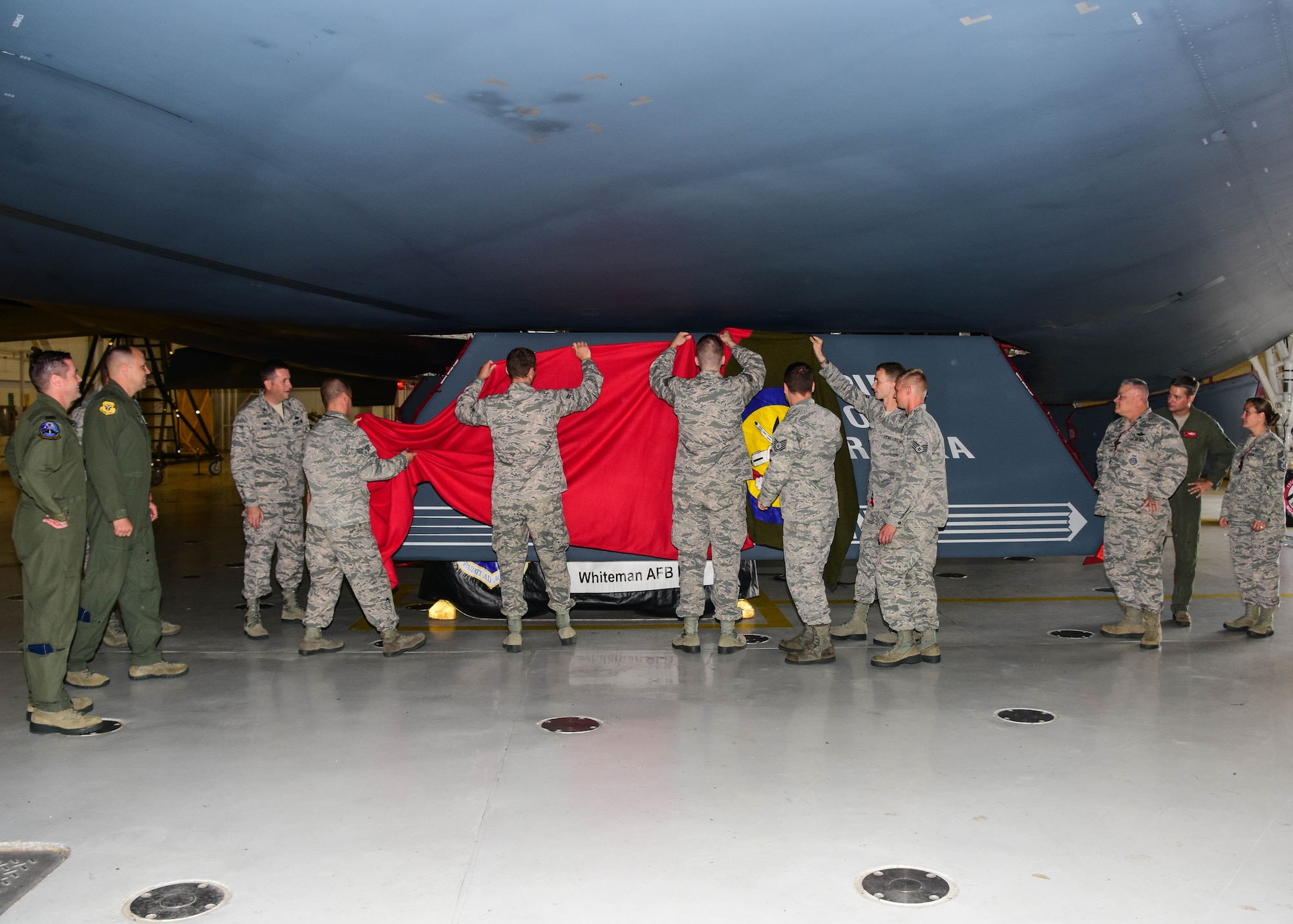 Members of the Missouri Air National Guard’s 131st Bomb Wing and the U.S. Air Force’s 509th Bomb Wing unveil a new paint scheme with the slogan “Lindbergh’s Own” on a gear door for the Spirit of Nebraska, a B-2 bomber, at Whiteman Air Force Base, Missouri, Aug. 4, 2018. The slogan is associated with the 110th Bomb Squadron, a subordinate unit of the 131st BW, and is tied to the late Charles A. Lindbergh, the unit’s most famous member. (U.S. Air National Guard photo by Senior Master Sgt. Mary Dale Amison)