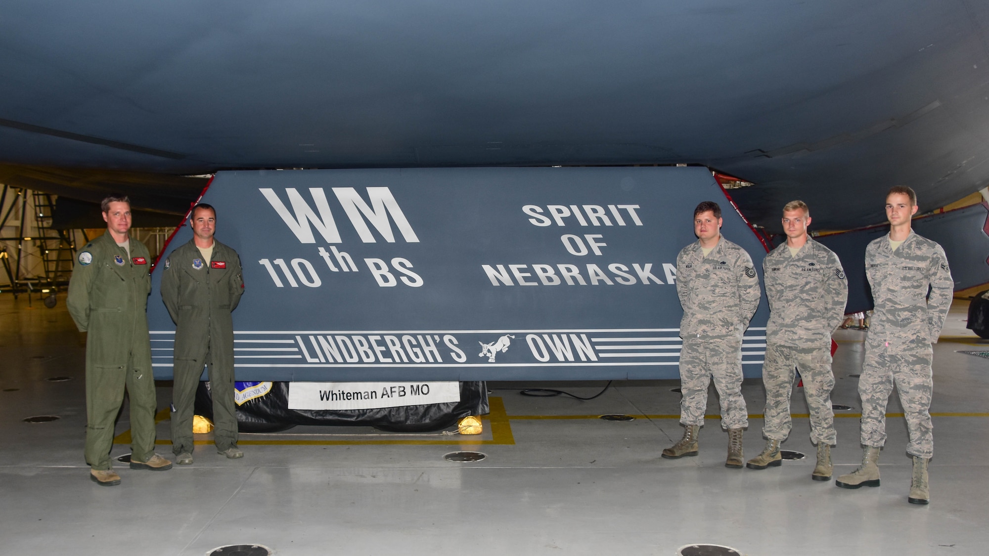 The dedicated pilots and aircraft crew chiefs for the Spirit of Nebraska, a B-2 bomber, gather after a new paint scheme with the slogan “Lindbergh’s Own” on a gear door was unveiled at Whiteman Air Force Base, Missouri, Aug. 4, 2018. The slogan is associated with the 110th Bomb Squadron, a subordinate unit of the Whiteman based 131st Bomb Wing, and commemorates the late Charles A. Lindbergh, the unit’s most famous member.