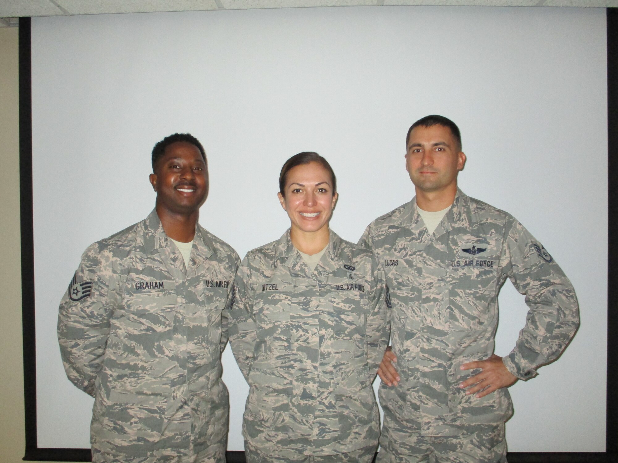 Staff Sgt. Germaine Graham, Tech. Sgt. Erin Nitzel, and Staff Sgt. Nick Lucas stand for a photo Aug. 8, 2018, at Tinker Air Force Base, Oklahoma. Graham, Nitzel and Lucas are the three newest members of the 513th Air Control Group safety office at Tinker Air Force Base, Oklahoma. (U.S. Air Force photo by Master Sgt. Andy Stephens)